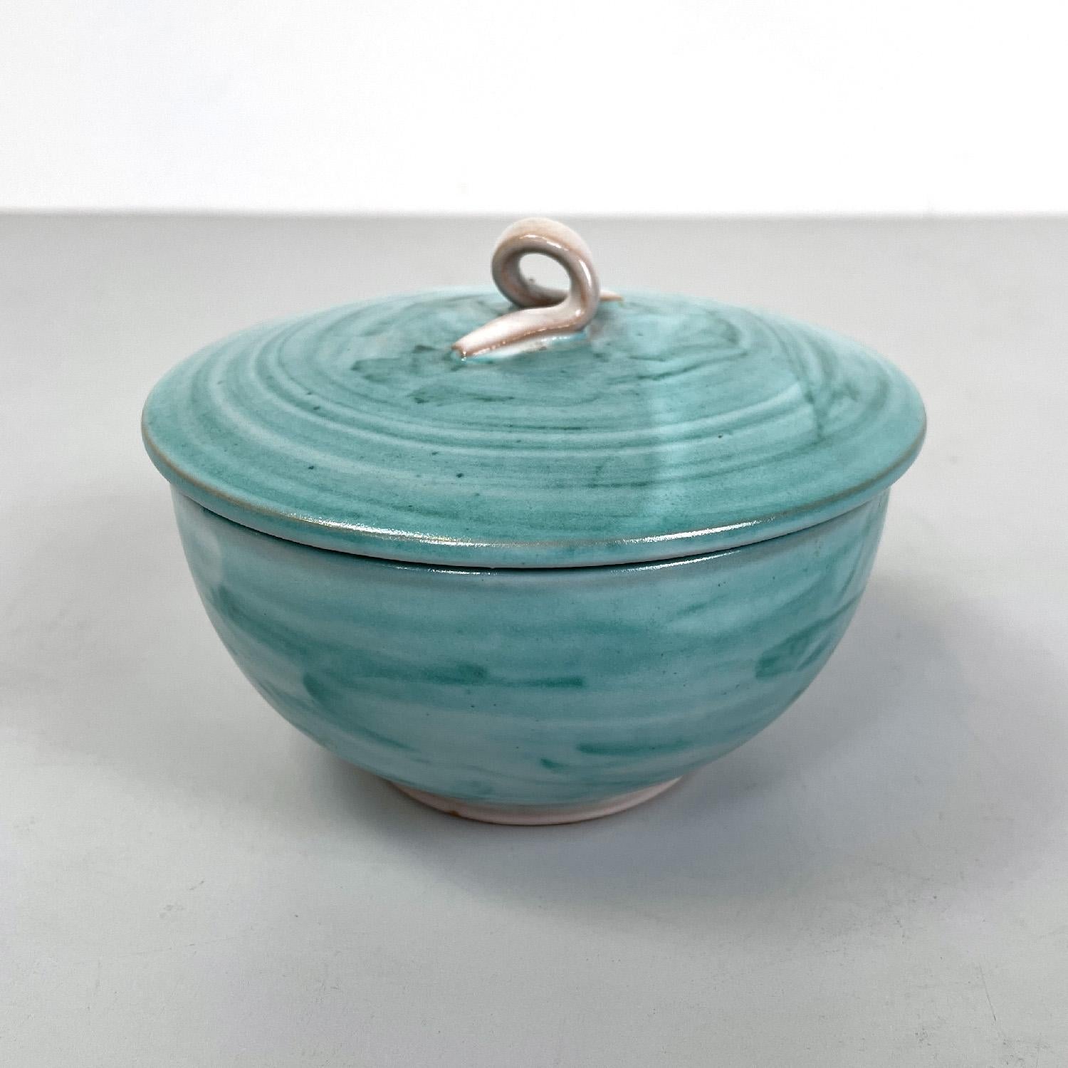 Italian modern light blue ceramic bowl by Bruno Gambone, 1970s
Round ceramic bowl. It has an enamel in shades of light blue on the outside and beige on the inside. On the cap there is an element in the shape of a knotted lace that acts as a handle,