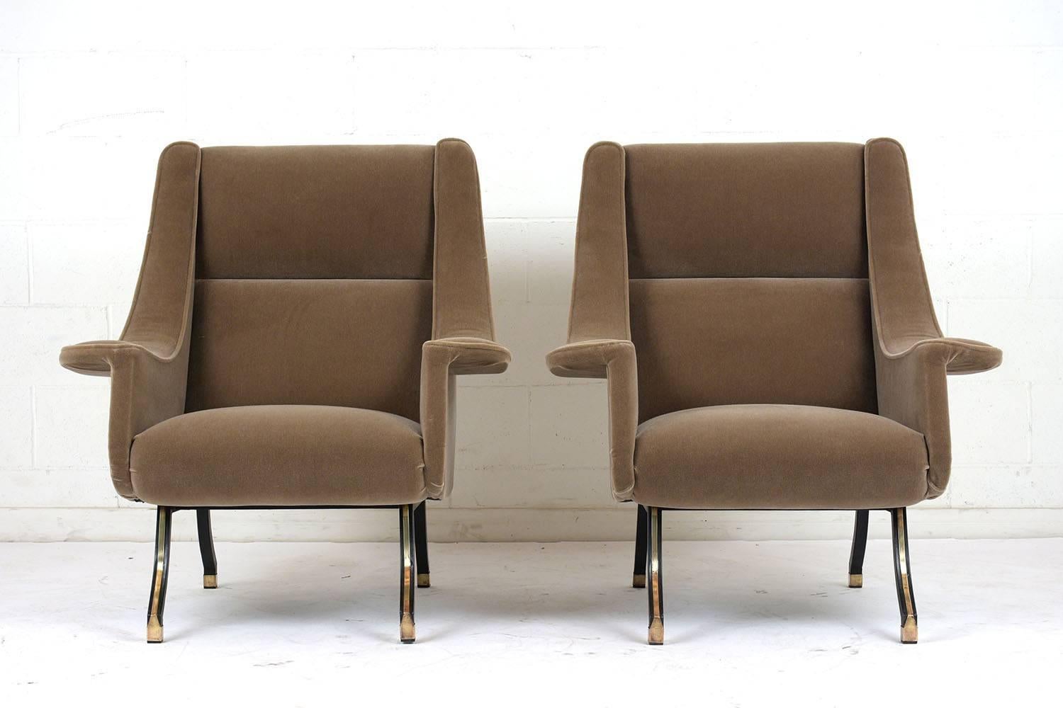This pair of 1960s Mid-Century Modern style lounge chairs have been completely restored. The chairs have a curved profile with ski slope arm rests. The comfortable seats have been professionally reupholstered in a tan color mohair fabric with single