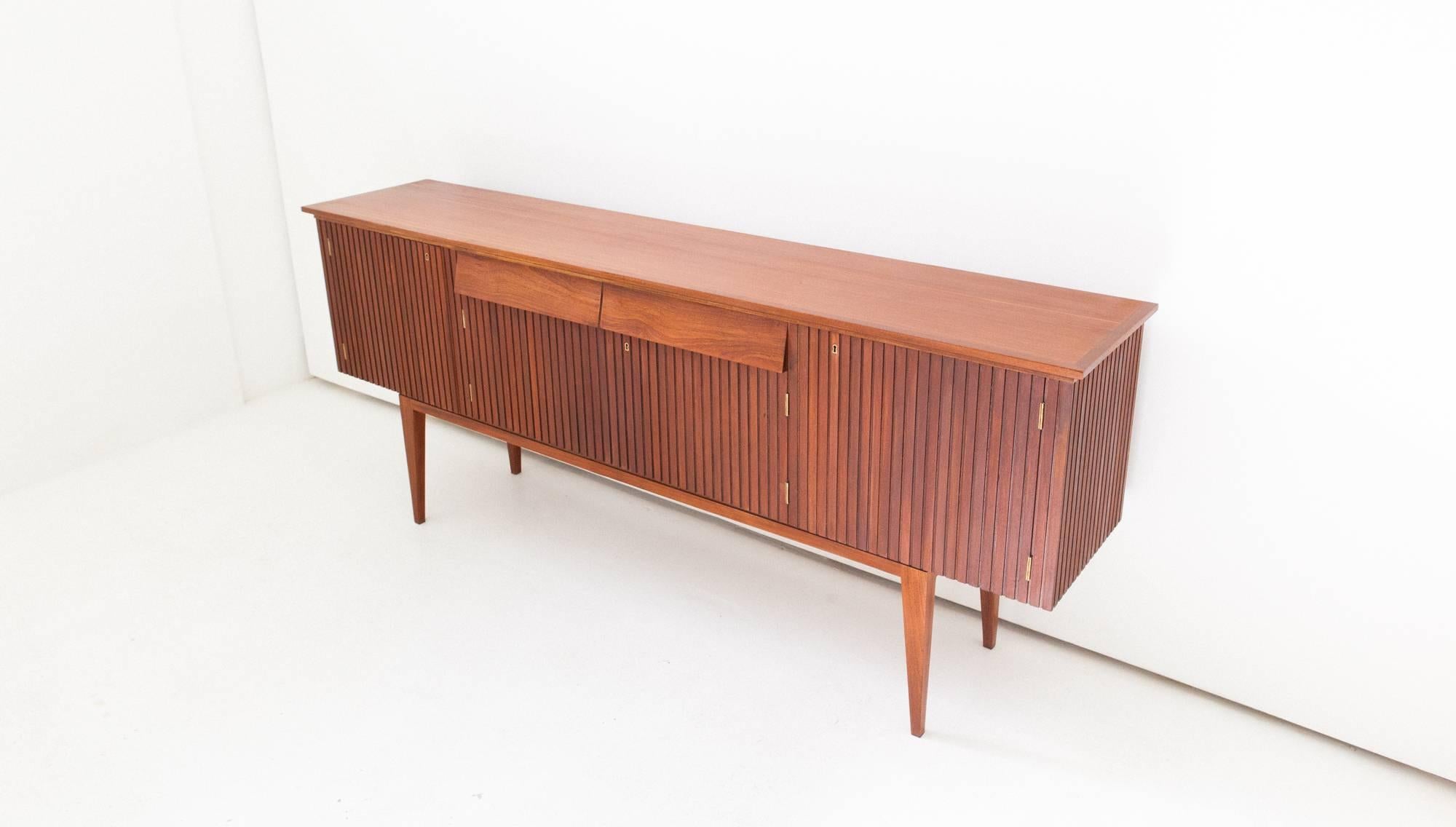 A modern credenza produced in Italy in the 1950s
Made of mahogany wood with brass details
Completely restored.



 