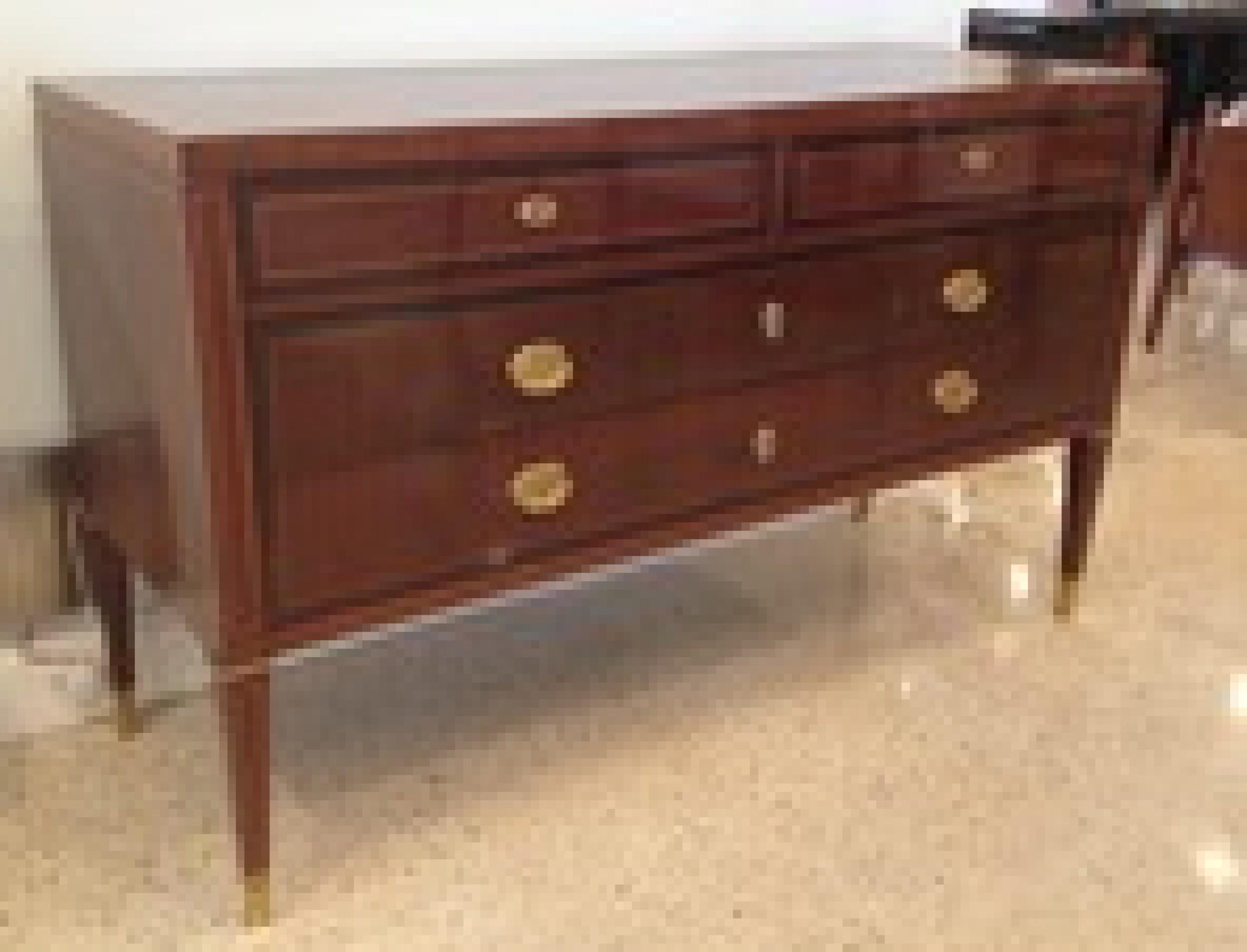 Italian Mid-Century Modern marquetry commode with a rectangular top above a case inlaid with greek key decoration and line banding accented with bronze sabots, pulls and escutcheons, containing two short drawers above two long drawers.