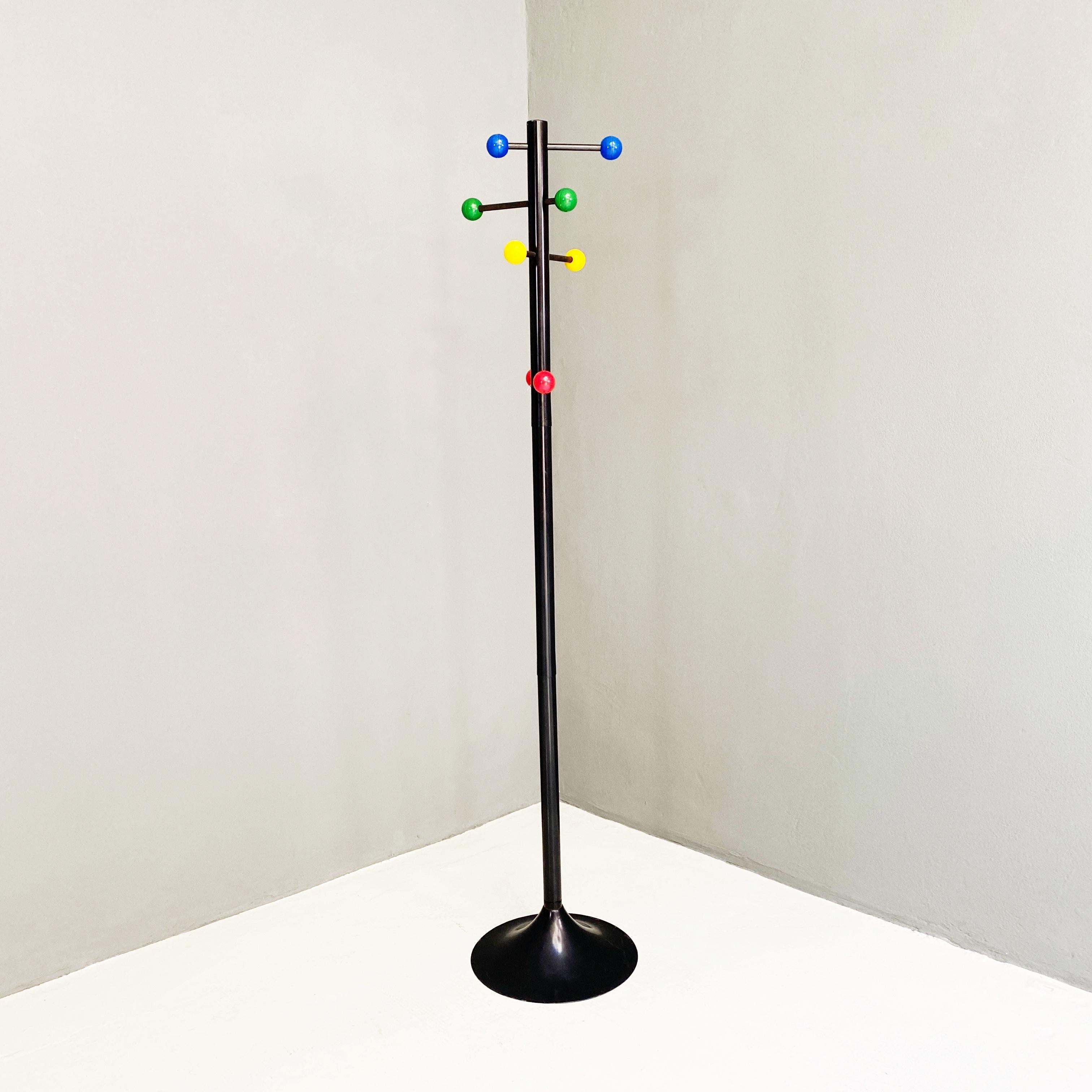 Metal coat rack with colored spheres, 1980s
Black metal coat rack with tulip base and colored plastic spheres at the ends of the five horizontal arms that cross the main axis.

Good conditions

Measures in cm 38x170h.