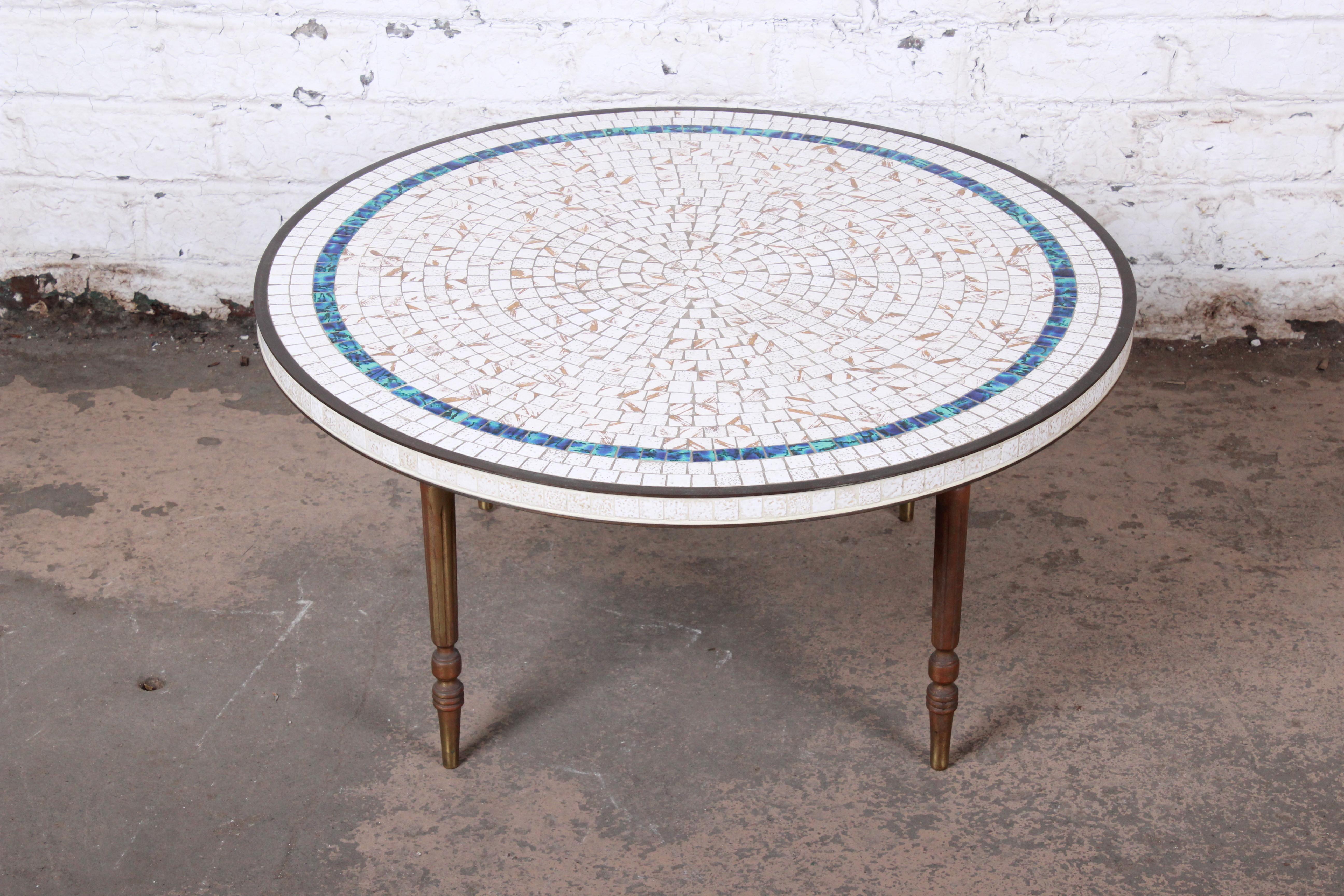 An exceptional Mid-Century Modern mosaic tile coffee or cocktail table

Imported by Luberto NYC

Italy, 1950s

Ceramic tile top and brass trim and legs

Measures: 32