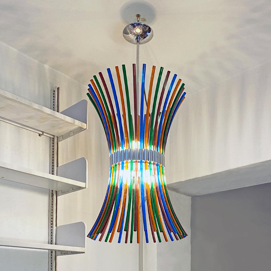 Italian Mid-Century Modern multicolored Murano chandelier with curved rods,1970s
Murano chandelier with curved rods, in five colors, with central metal structure equipped with 8 E27 lamp holders and chromed details, 1970s.
Manual interlocking
