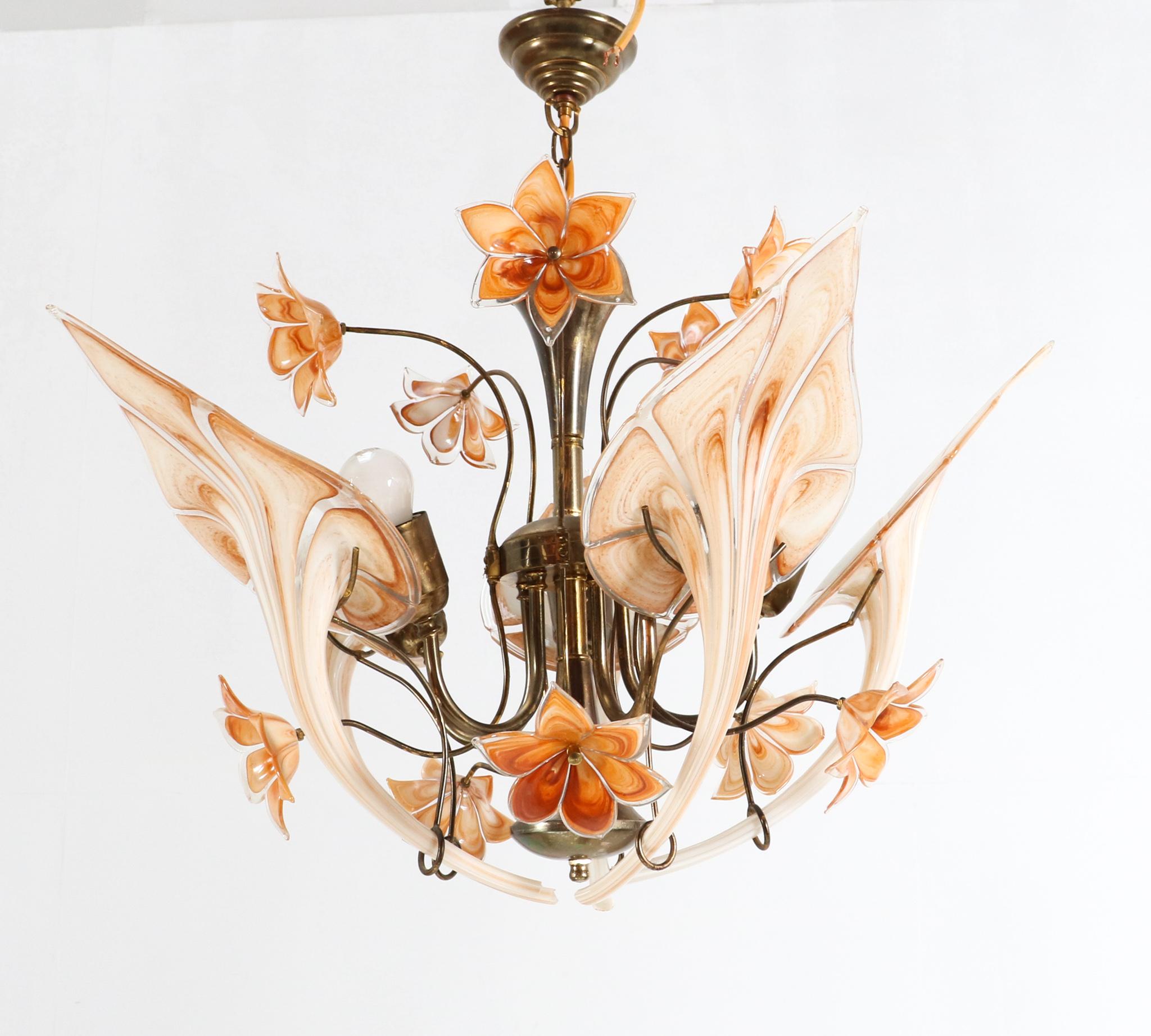 Amazing  Mid-Century Modern Vintage Murano glass five light pendant chandelier.
Design by Franco Luce for Seguso.
Striking Italian design from the 1970s.
Handcrafted forged metal frame with original gilt finish.
The five original Murano leaves which