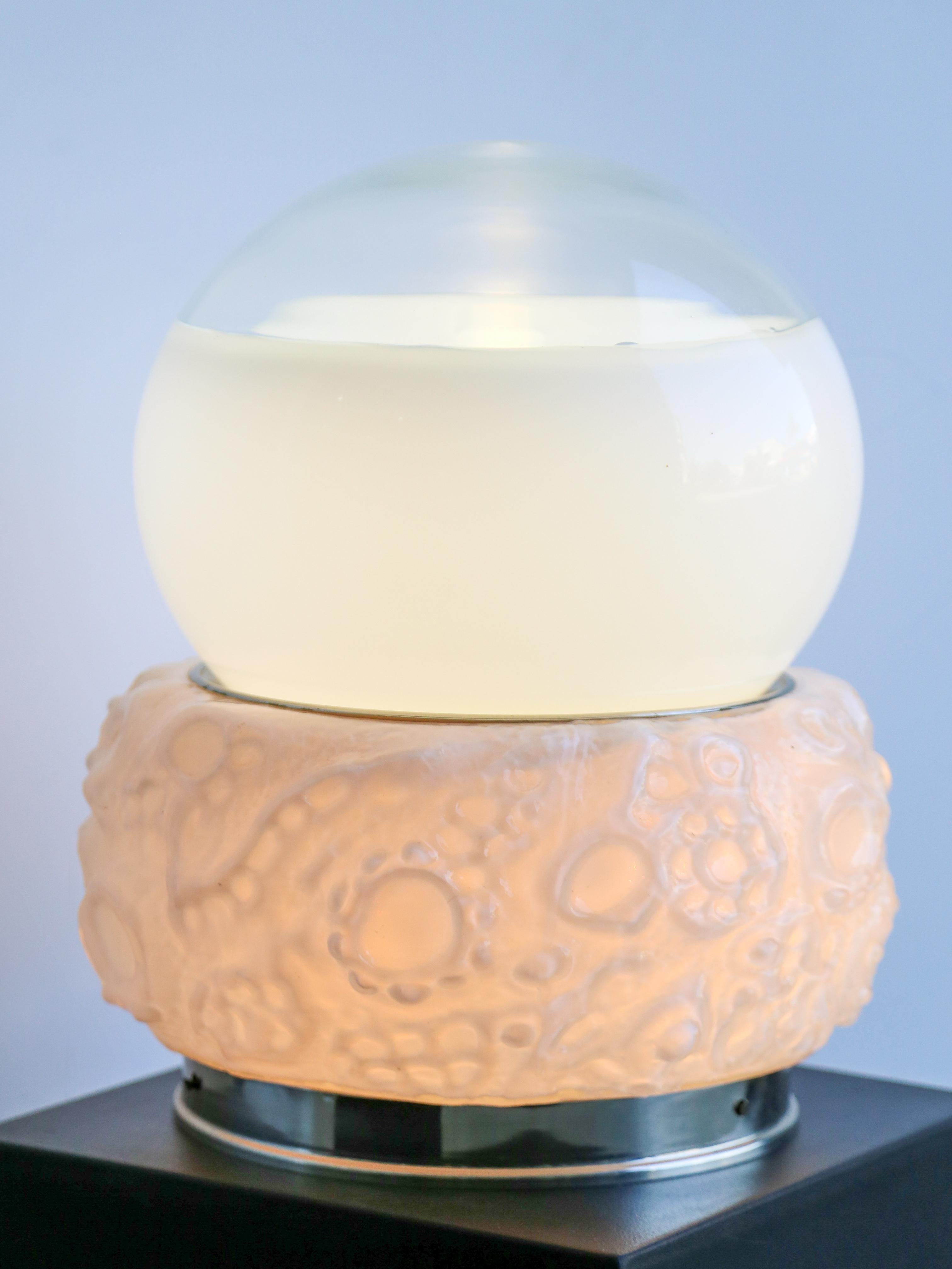 Osso ( bone ) table lamp by Mazzega.

Mazzega is an Italian glass company known for its beautiful and artistic glasswork, particularly in the field of Murano glass. Murano glass is a renowned type of glass that originates from the island of Murano,