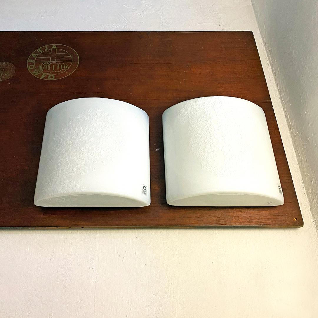 Italian Mid-Century Modern Murano glass La Murrina sconces by Leucos, 1970s
Pair of La Murrina wall lamps in murano glass with white glass lampshade with geometric motifs, with attachment for two bulbs inside.
Produced by Leucos in the 70s, brand
