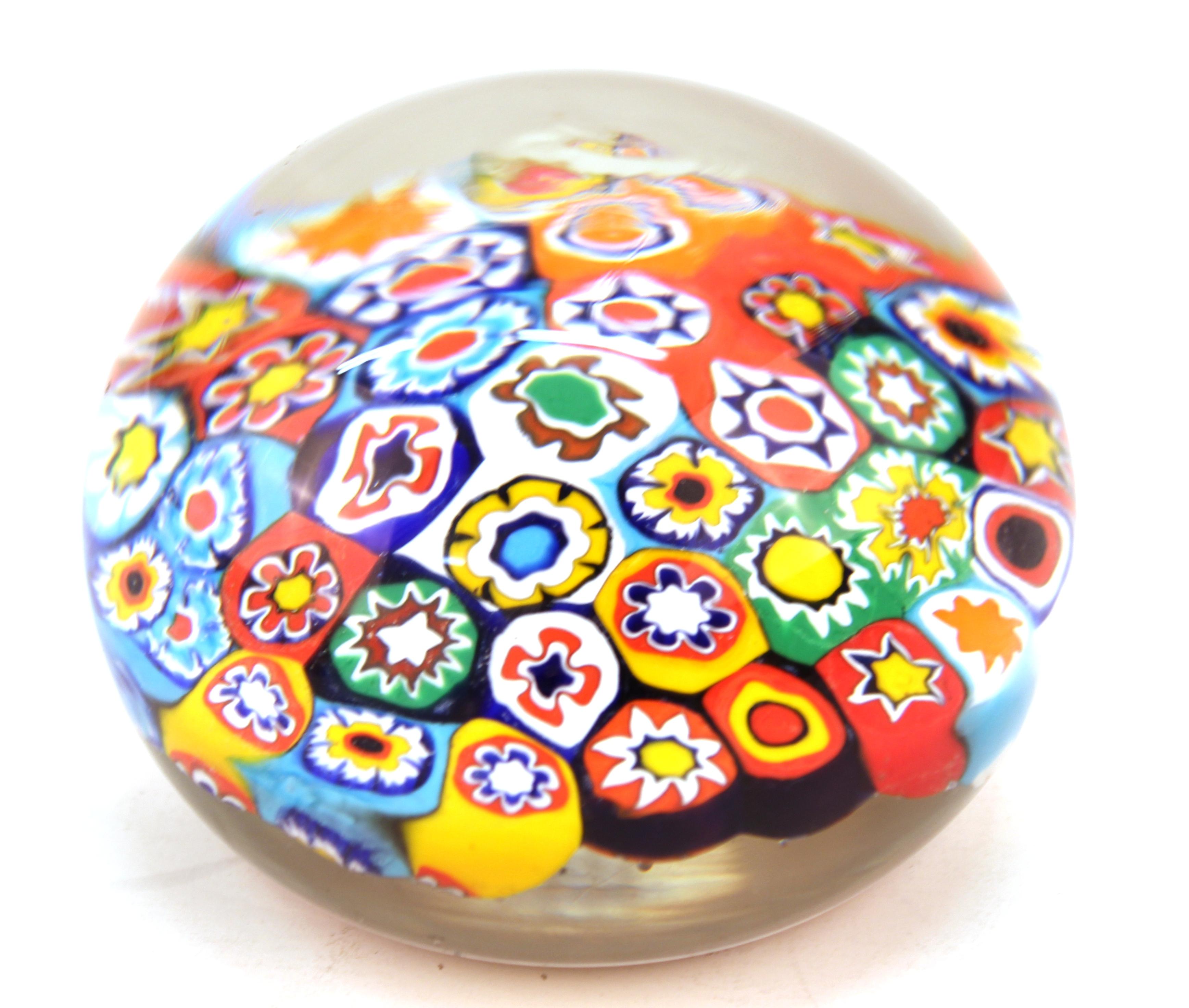 Italian Mid-Century Modern Murano art glass paperweight with millefiori floral motif. The piece has an old Italian label on the bottom and is in great vintage condition.