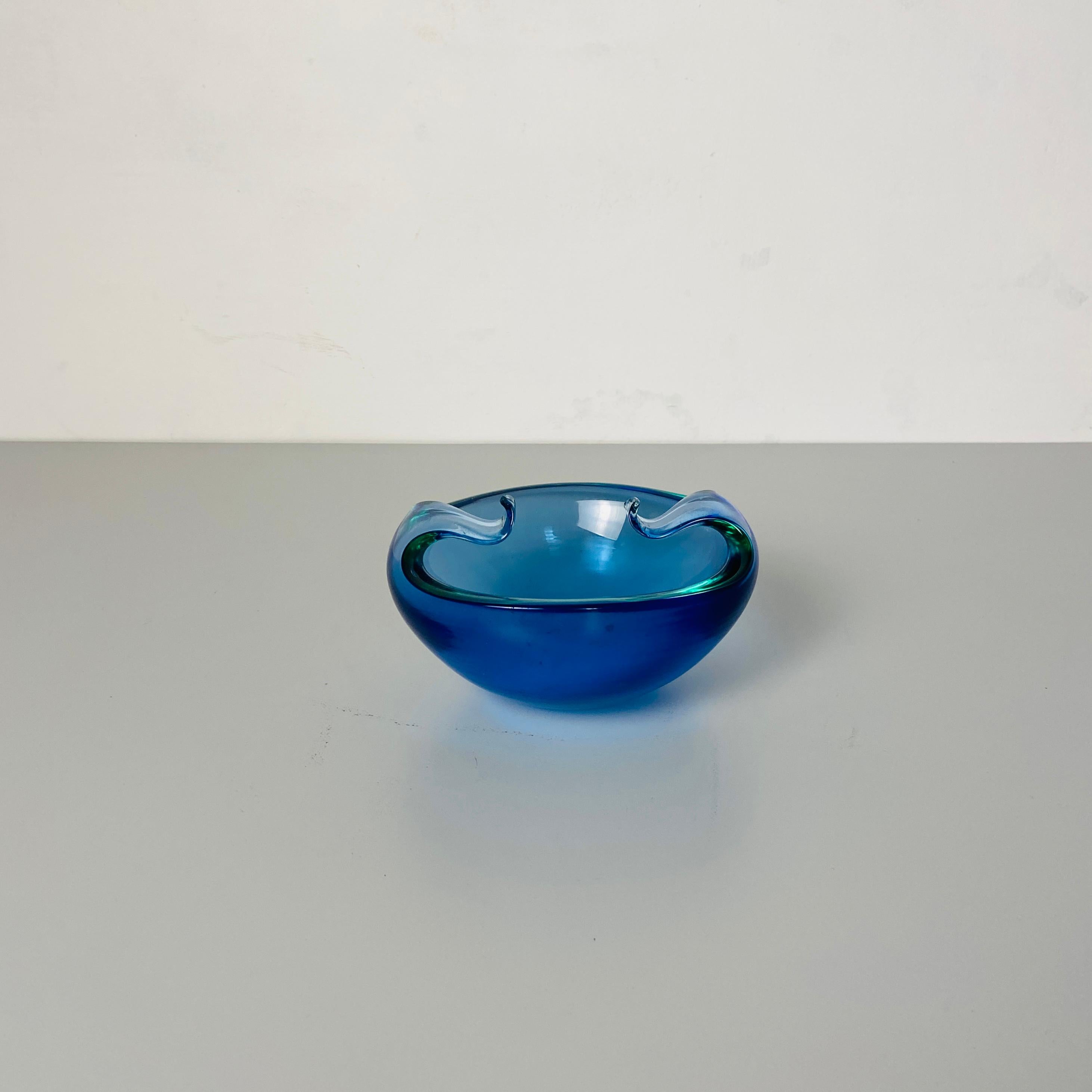 Italian mid-century modern Murano glass object holder with curled arms, 1970s
Blue Murano glass object holder in shades of blue and green, with two curled arms at the top.
This is a perfect detail can be rich and attractive your desk or your
