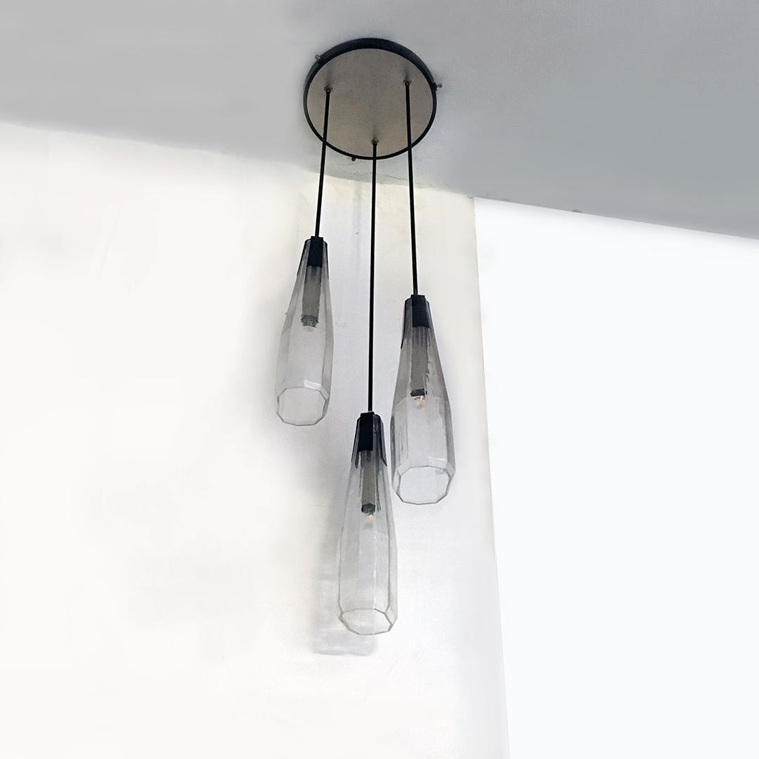 Italian Mid-Century Modern Murano glass three-light chandelier, 1970s
Murano glass three-light chandelier with black metal rods, round ceiling in satin steel and printed Murano glass with a decagonal base.

Excellent general condition, several