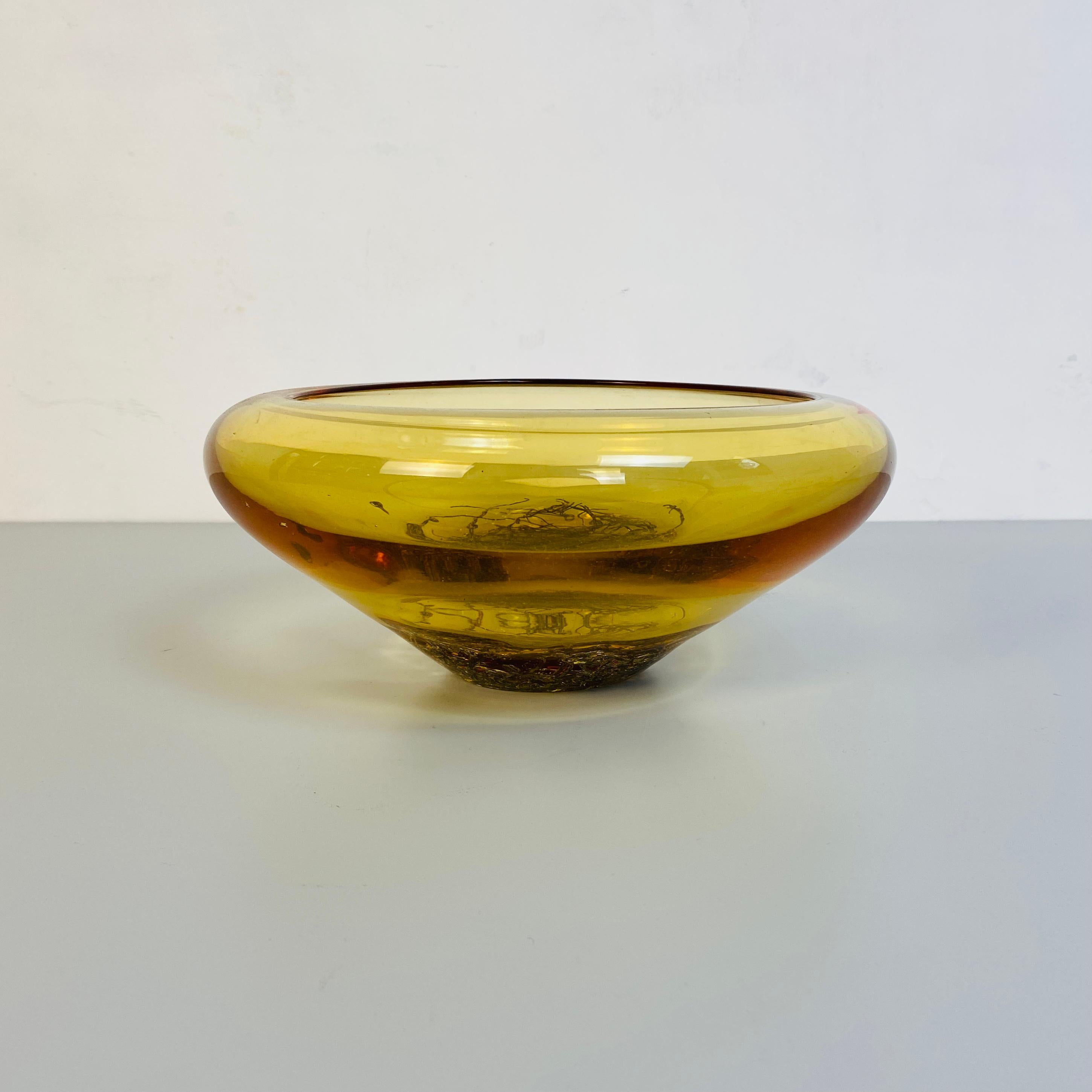 Italian Mid-Century Modern murano glass yellow bowl, 1970s 
Irregular shaped yellow bowl in Murano gold glass with internal metal decoration incorporated within the glass, produced between the 1970s and 1980s period this is perfect in an entrance on