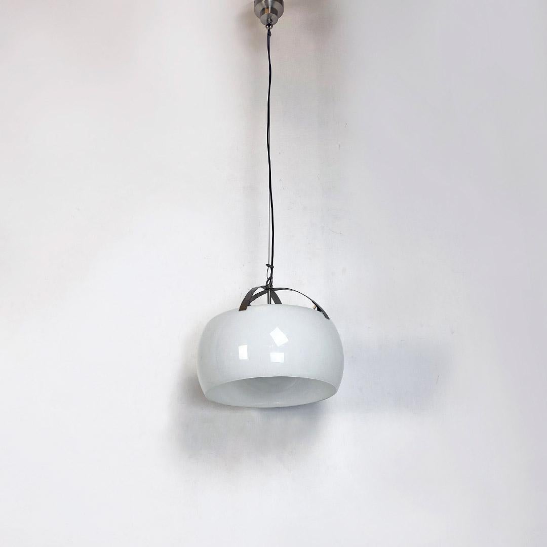 Italian Mid-Century Modern opal glass and metal Omega chandelier by Vico Magistretti for Artemide, 1962.
Omega model chandelier characterized by a cylindrical diffuser, internally frosted, which encloses an opal glass sphere, supported by a cross