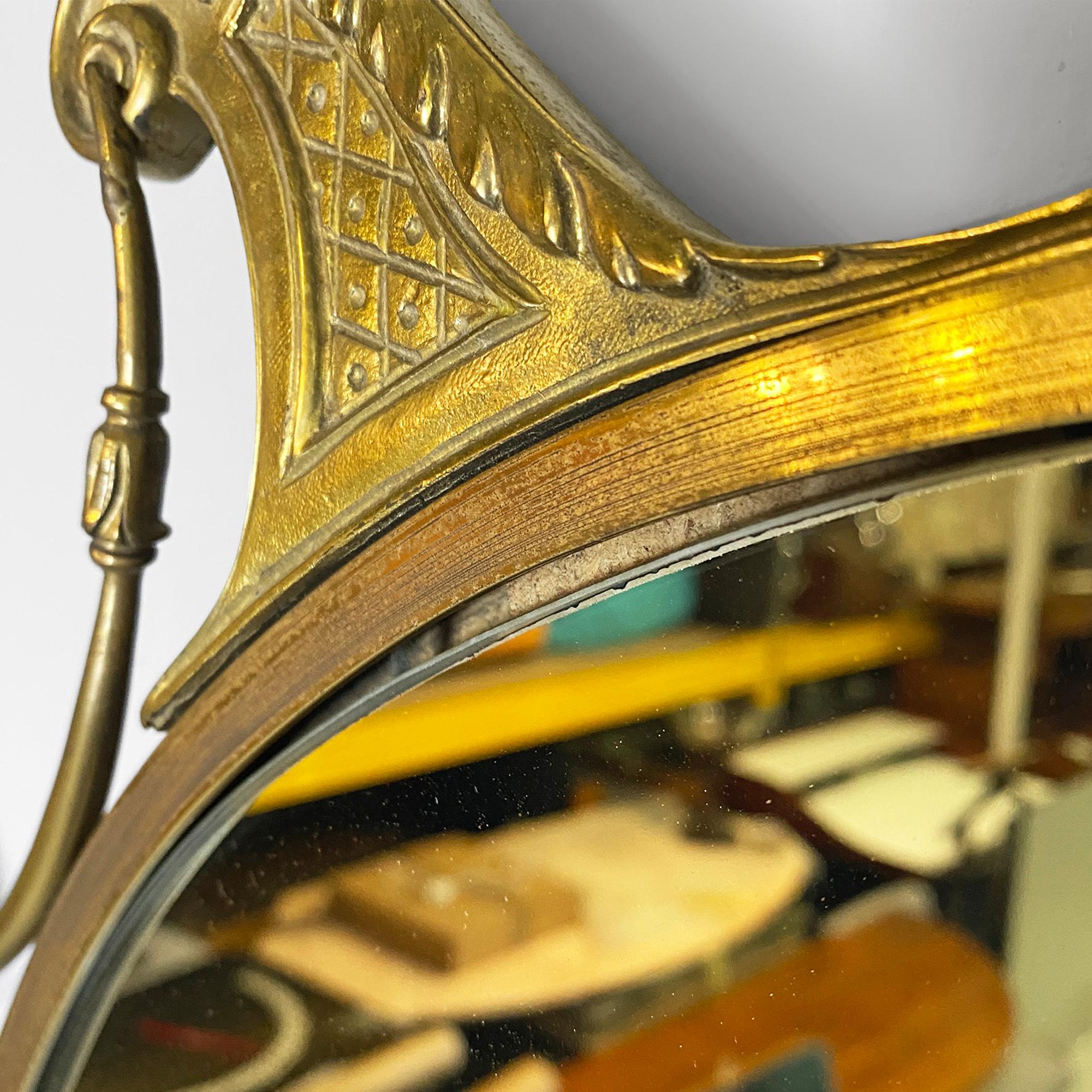 Oval brass wall mirror, with classic friezes on the upper part of the frame.
1950s
Good general condition of the brass structure, however a small piece of mirror is missing under the glass, in the lower part of the object.
Measurements in cm: