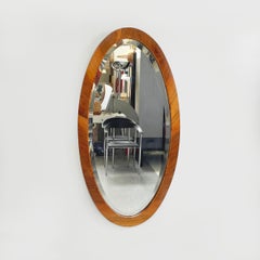 Italian mid-century modern Oval shaped wall mirror with wooden frame, 1960s