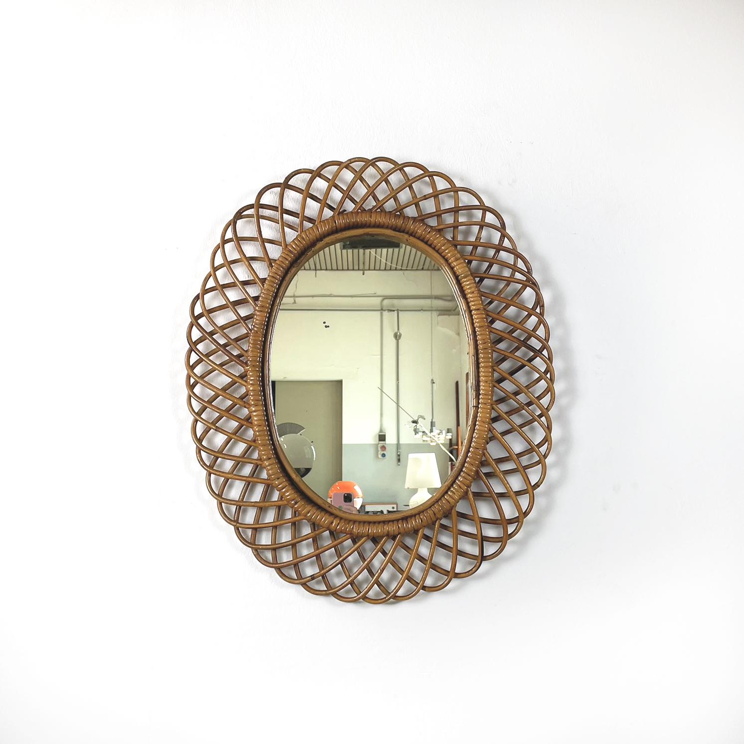 Italian mid-century modern Oval wall mirror in rattan, 1960s
Vintage fantastic oval wall mirror in rattan. On the whole profile of the mirror there is a finely woven rattan arched decoration.
This wall mirror is from 1960s.
Good conditions. It has a