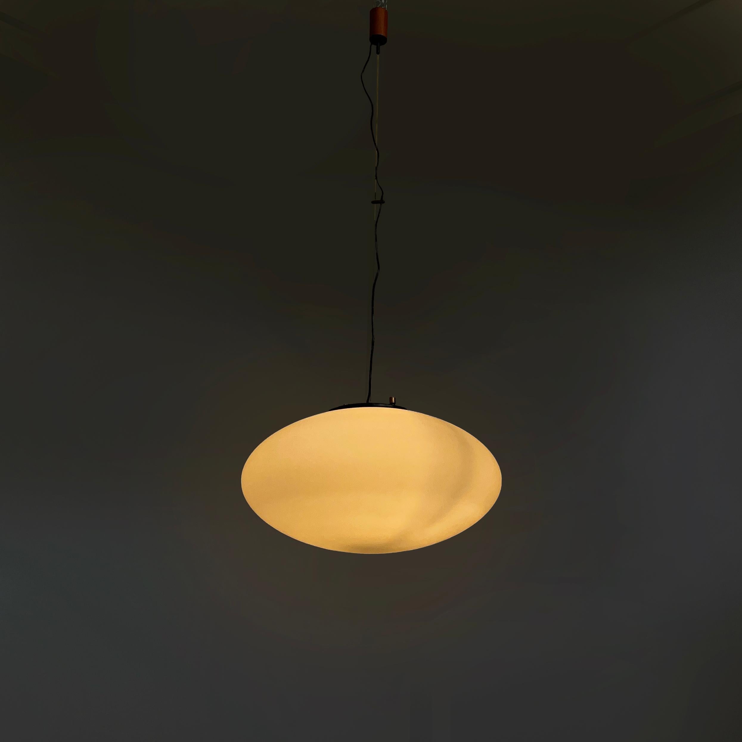 Lustre Pastil italien en verre opalin du milieu du siècle dernier par Stilnovo, années 50
Lustre avec diffuseur pastillé elliptique en verre opalin. La structure est en métal noir avec deux vis cylindriques en laiton. Fixation cylindrique au