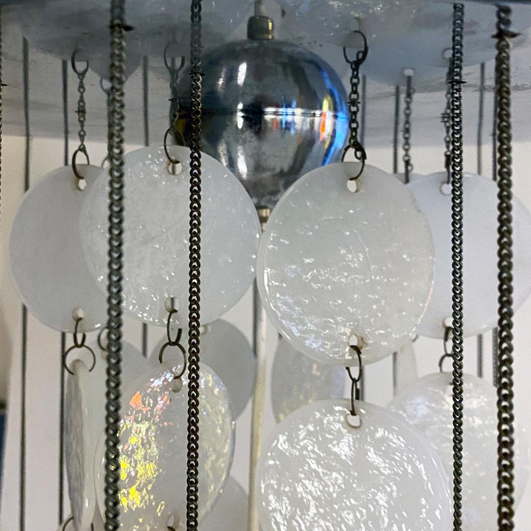 Italian Mid-Century Modern white glass Cascade chandelier, 1970s
Cascade chandelier composed of a round steel plate and suspended chains of different sizes, to which white glass rods are anchored, linked to each other by two rings. The glass