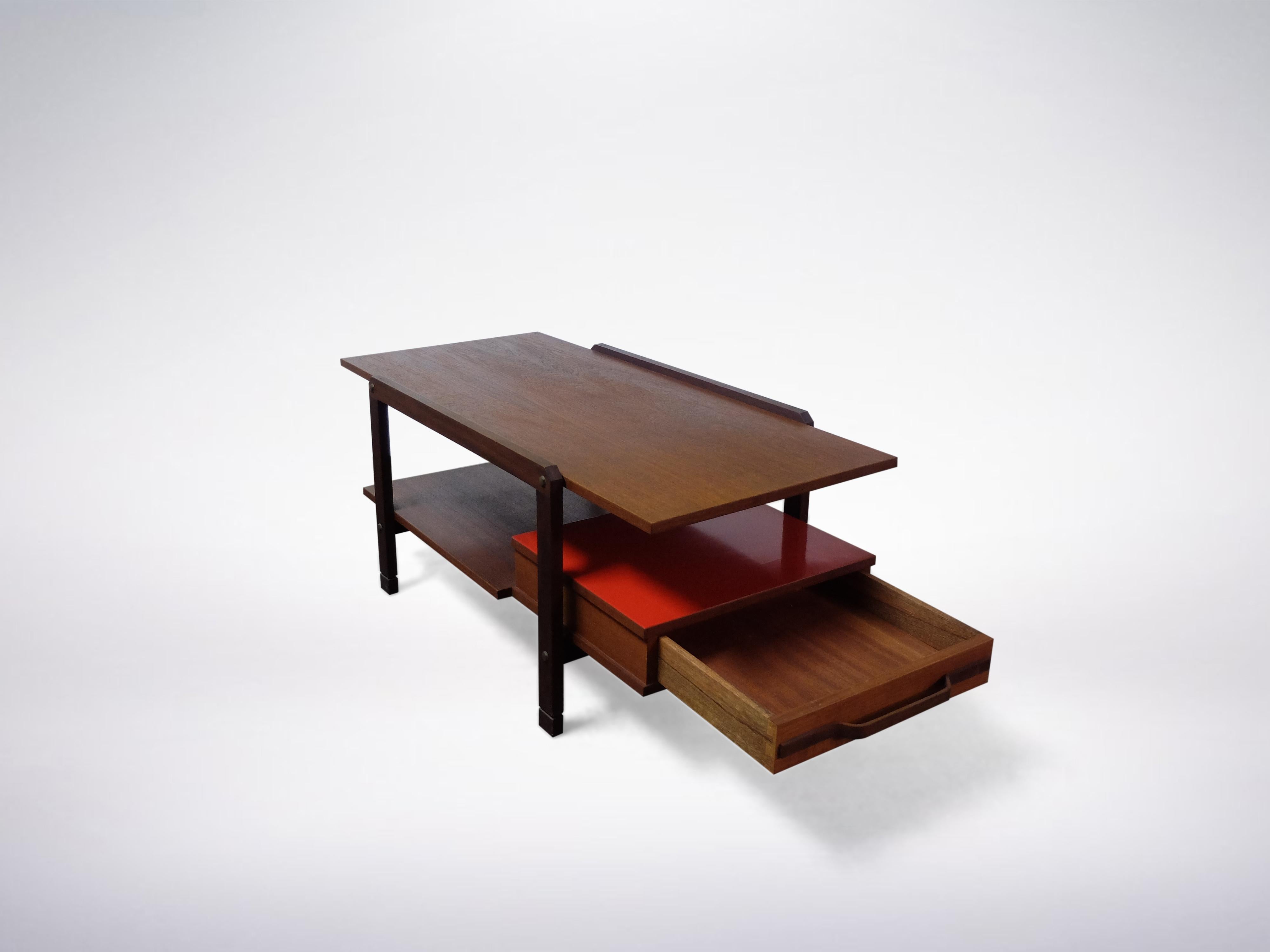 Italian Mid-Century Modern Rationalist coffee table
1950s
Rare lacquered wood low table in two tiers with a red drawer. This well maintained coffee table is elegant and sleek. There is a fine finish to its look with the existence of three panes