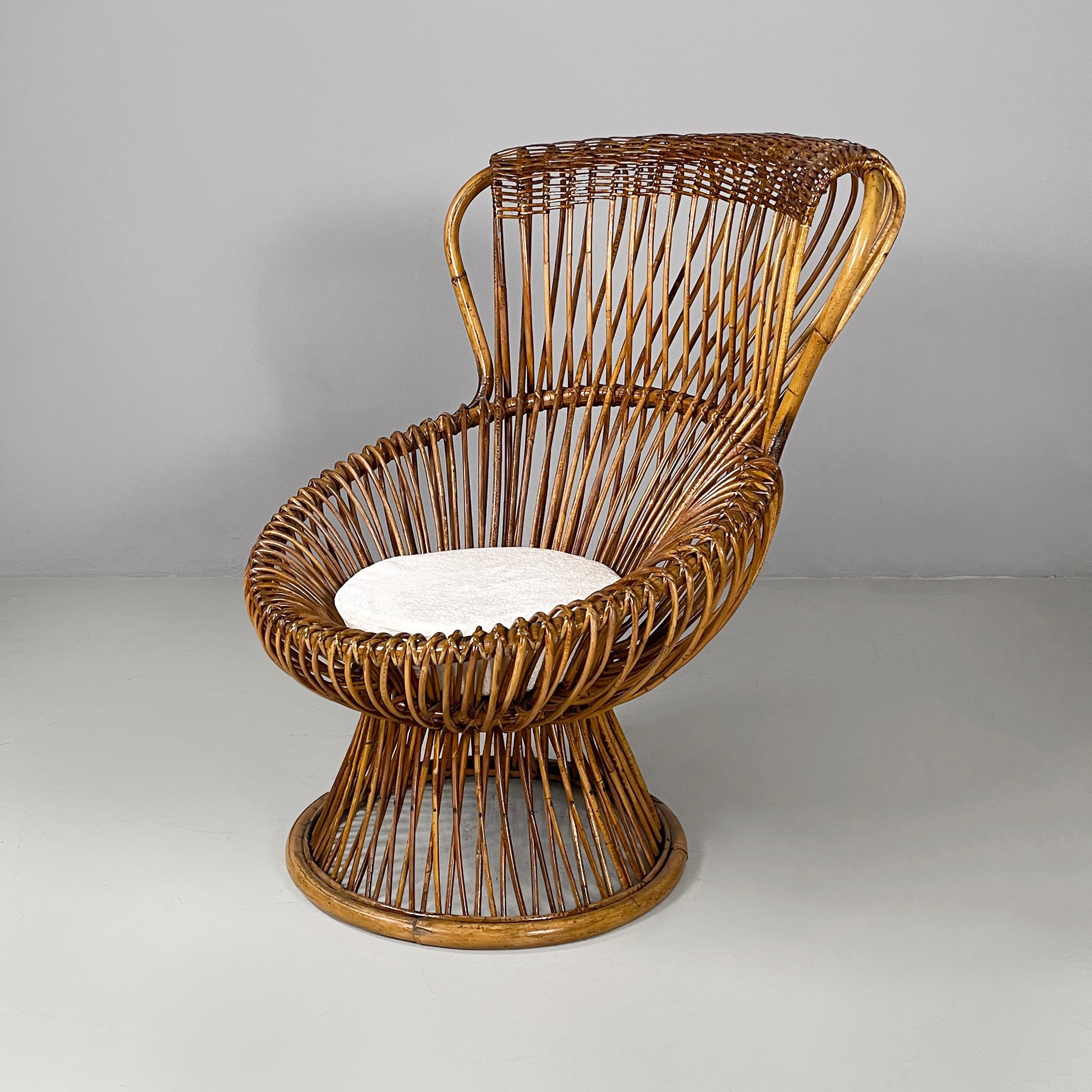 Italian mid-century modern Rattan armchairs Margherita by Franco Albini for Bonacina, 1950s
Pair of armchairs mod. Margherita entirely in rattan with a round base. The backrest and seat follow curved lines and enveloping and rounded shapes. A round