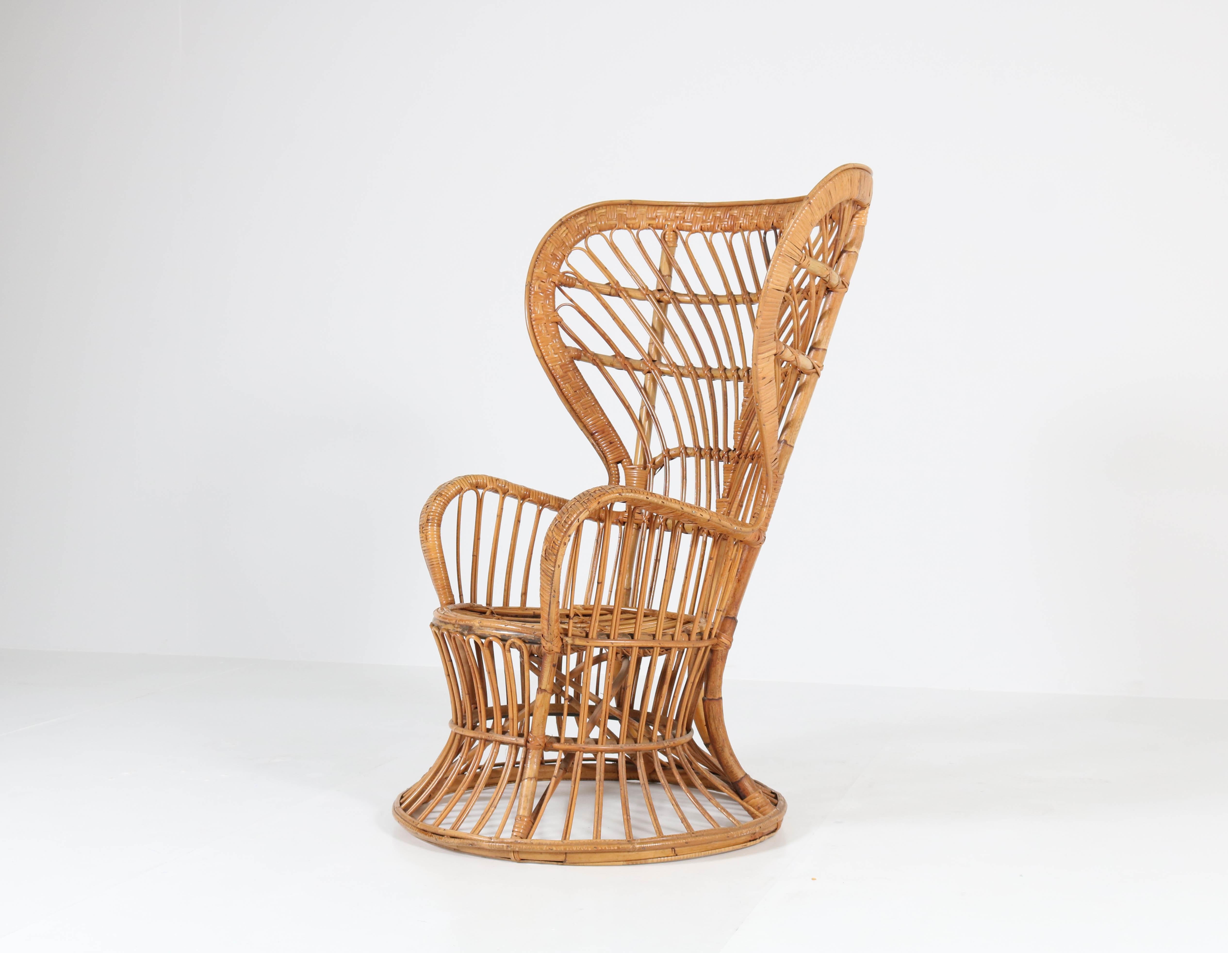 Offered by Amsterdam Modernism:
Italian Mid-Century Modern rattan wingback chair by Lio Carminati for Vittorio Bonacina Como, 1950s.
The architect Gio Ponti used these chairs for the ocean liner he designed 