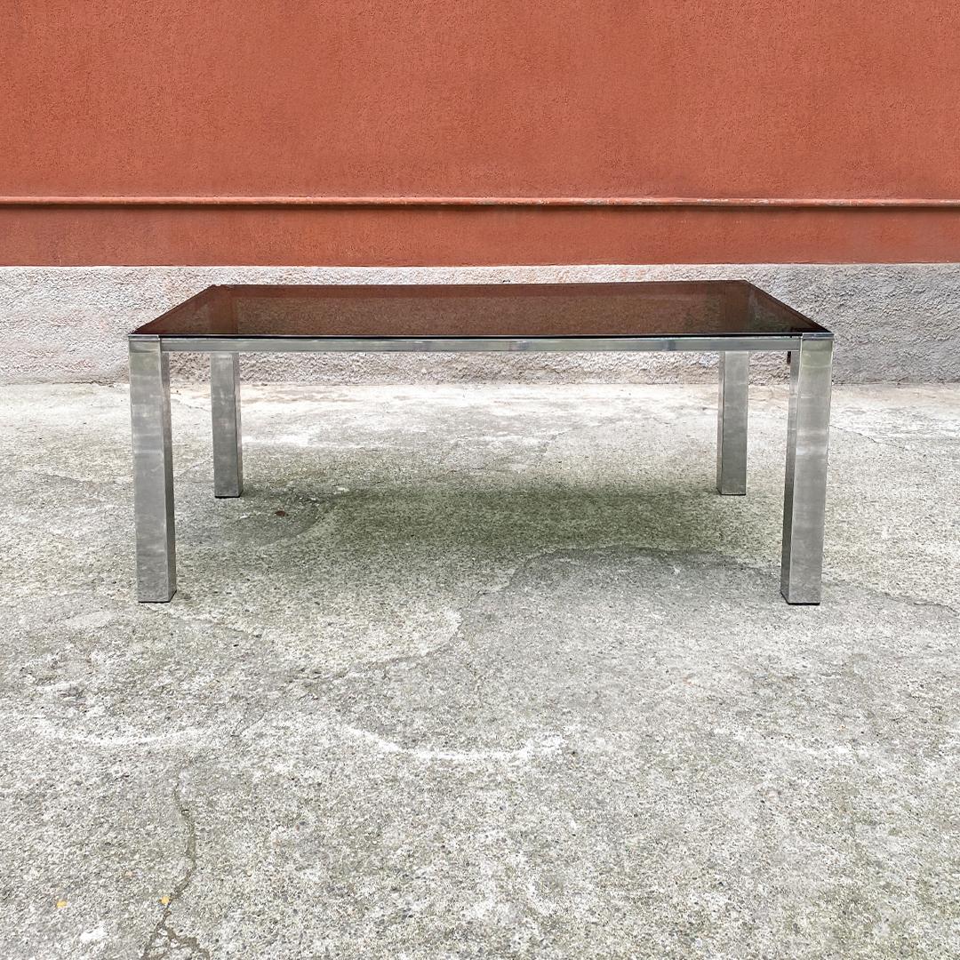 Italian Mid-Century Modern rectangular table with smoked glass top, 1970s
Rectangular table with smoked glass top, chromed steel structure and square section legs.

Very good condition.

Measurements 72 x 90 x 76 H cm.