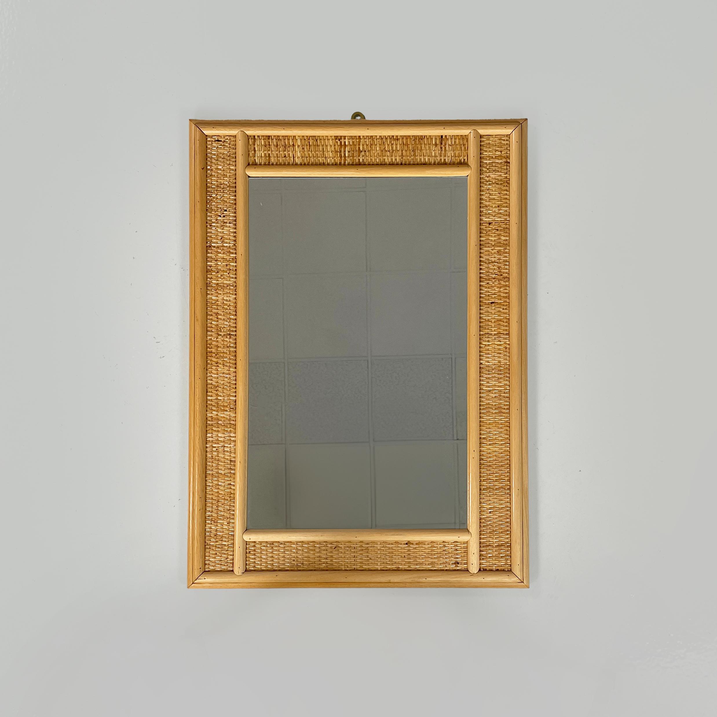 Italian mid-century modern Rectangular wall mirror in wood and rattan, 1960s
Rectangular wall mirror in wood and rattan. The frame has two wooden strips on each side and a strip of woven rattan in the middle.
1960s.
Good condition, light signs of