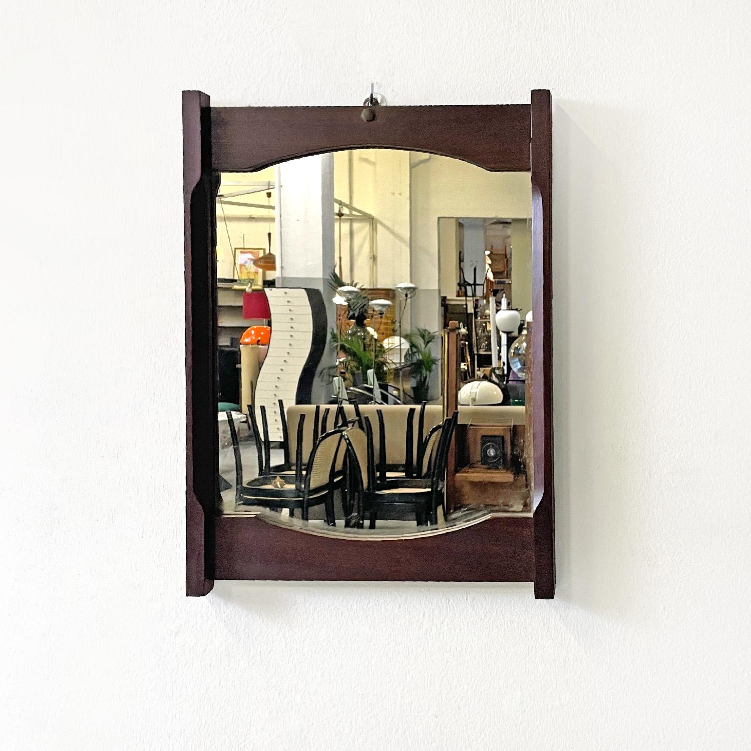 Italian mid-century modern rectangular wooden wall mirror, 1960s
Rectangular wall mirror. The structure is in dark wood, on the sides it has two slats slightly longer than the central rectangle. In the central internal part, both upper and lower,