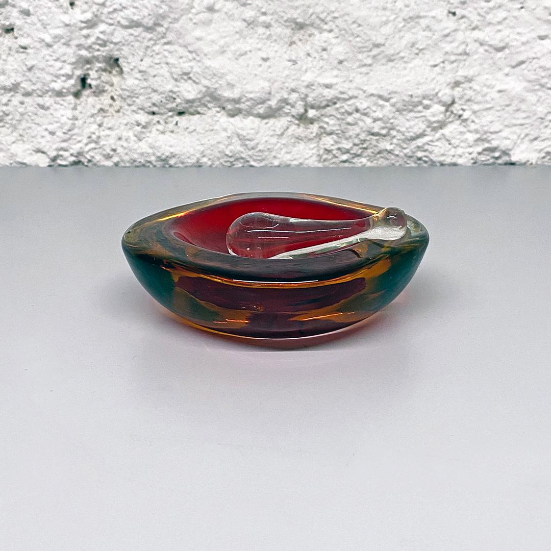 Italian Mid-Century Modern red Murano a with yellow and green shades, 1970s
Red Murano glass ashtray with yellow and green shades with transparent glass cigarette extinguisher, 1970s
1970s From the Sommersi series
This is a perfect detail can be