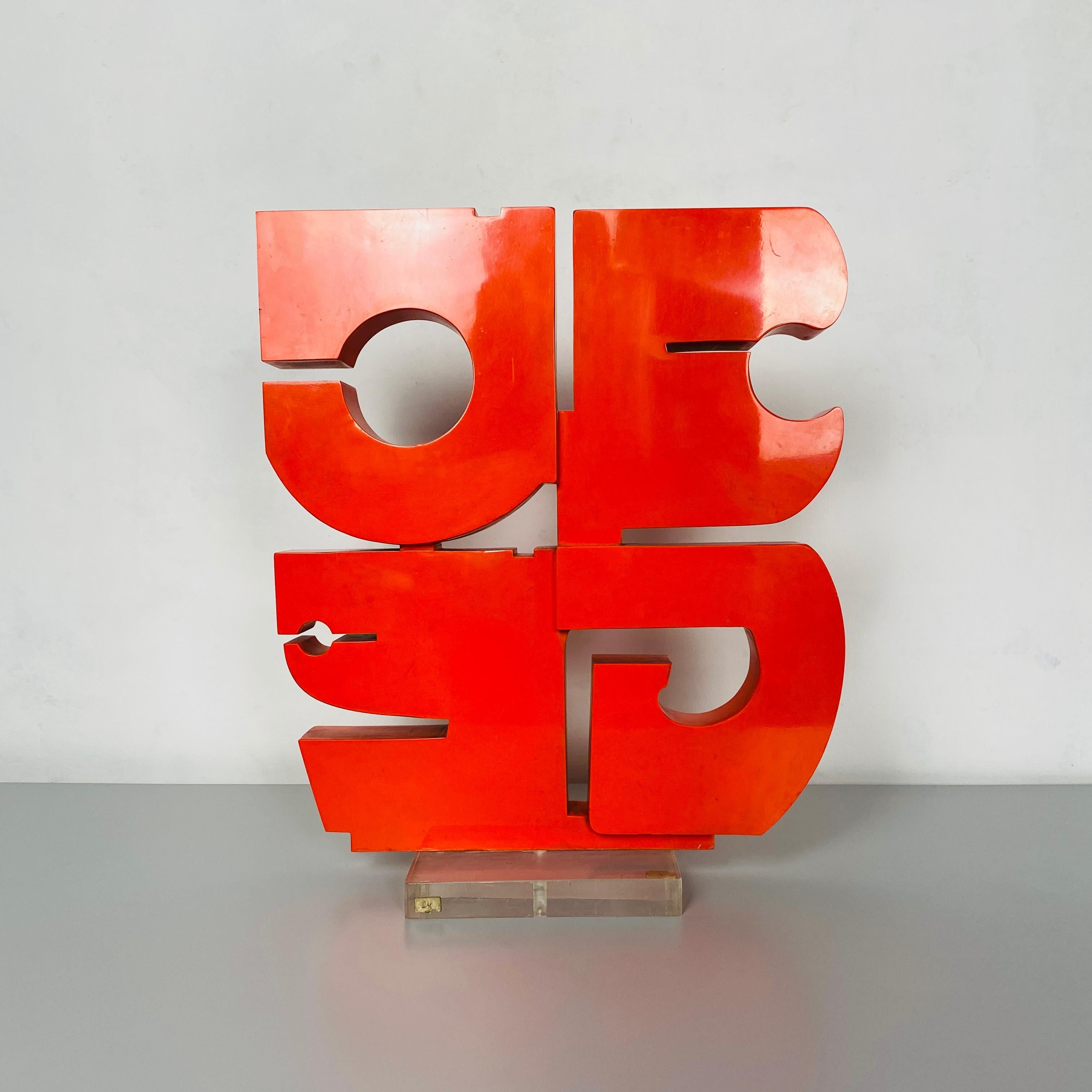 Italian Mid-Century Modern red plexiglass sculpture by Edmondo Cirillo, 1970s
Red plexiglass sculpture representing letters of the alphabet, supported by a transparent plexiglass base.
By Edmondo Cirillo.

There are some light scratches, good