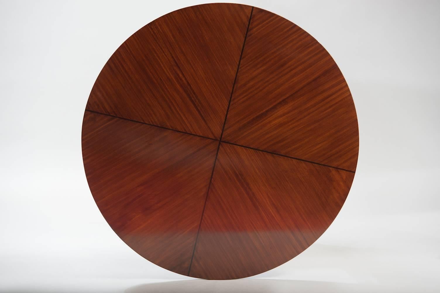 Mahogany Mid-Century Modern round dining table with inlay on top.