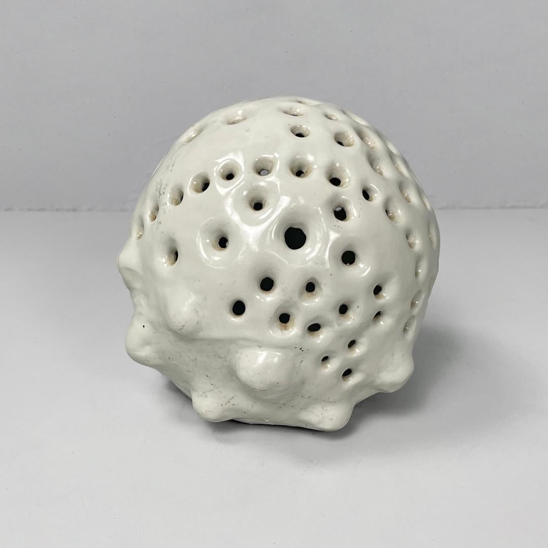 Italian mid-century modern round flower vase in ceramic, 1950s
Semi-spherical white ceramic flower vase. It features several holes for flower stems, and the bottom surface features several protruding semi-spheres.
1950s
Vintage condition, signs of