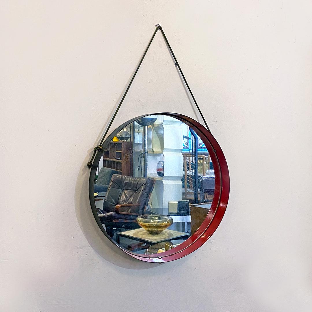 Italian Mid-Century Modern round metal mirror, 1960s
Round metal mirror with red frame inside and matt black outside, original rope and brass details.

Good conditions.

Measurements 7 x 52 x 80 H cm.
      