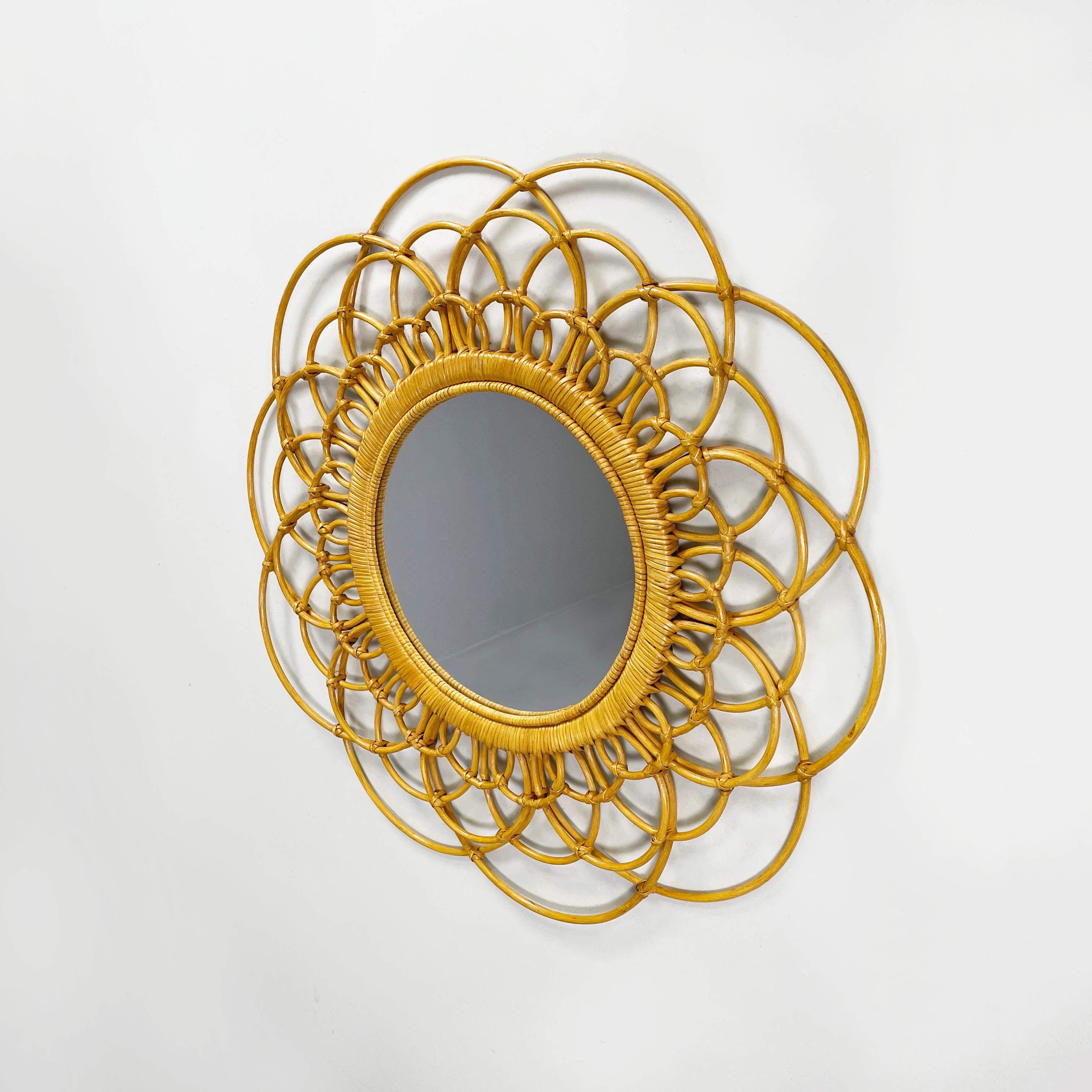 Italian mid-century modern Round rattan wall mirror with curved bamboo, 1960s
Round rattan wall mirror. The mirror frame is made up of a weave of rattan with arched curved and finely intertwined bamboo strips.
1960 approx.
Good condition, light