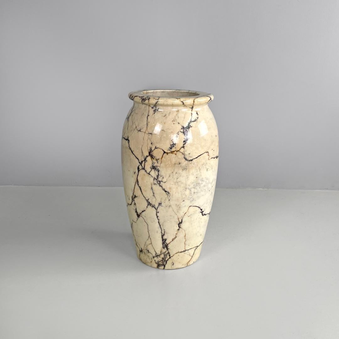 Italian mid-century modern round umbrella stand in arabesque marble, 1950s
Round umbrella stand in arabesque marble. The structure follows rounded curved lines, in the upper part there is an edge, in the central part the circumference widens and