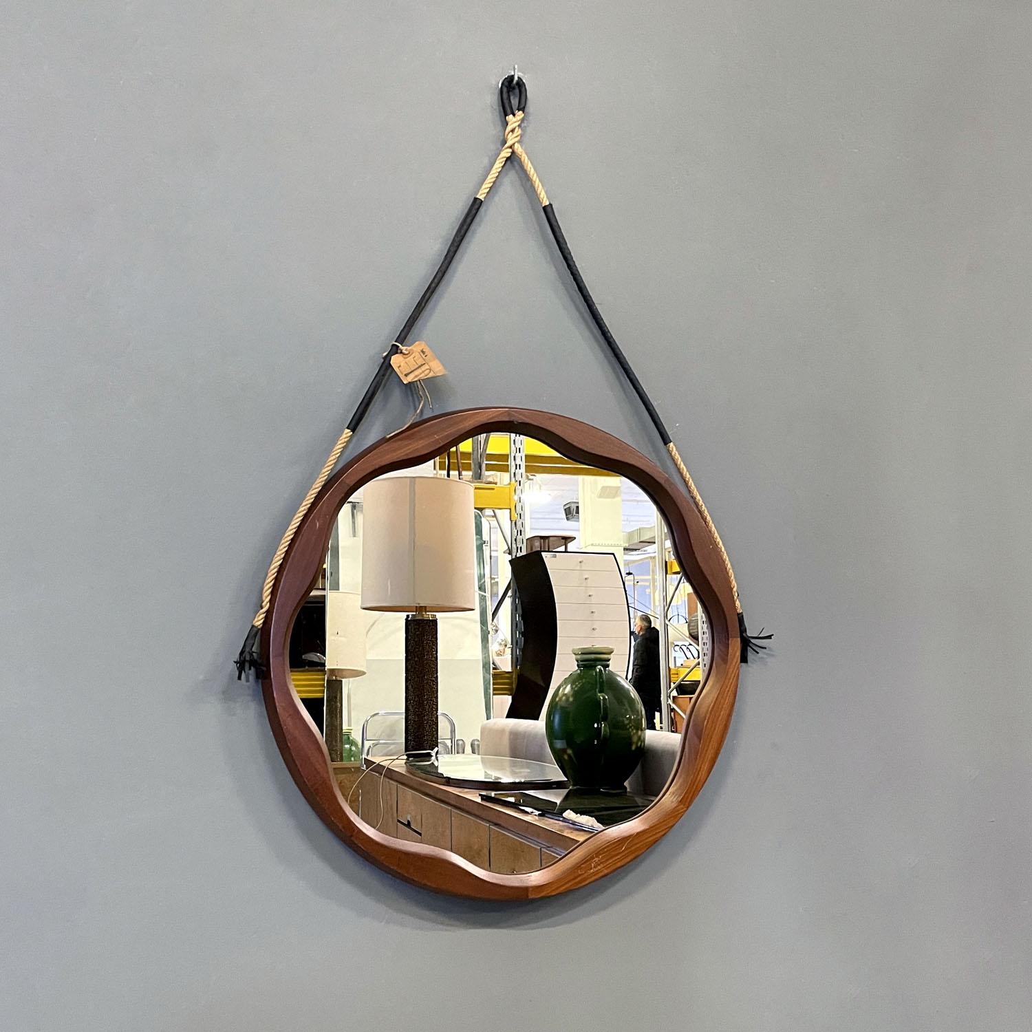 Italian mid-century modern rounded wooden wall mirror with rope, 1960s
Round wooden wall mirror. The frame on the inside is shaped with regular wavy lines to create a decoration. The frame is thick and the mirror part remains internal. To hang the