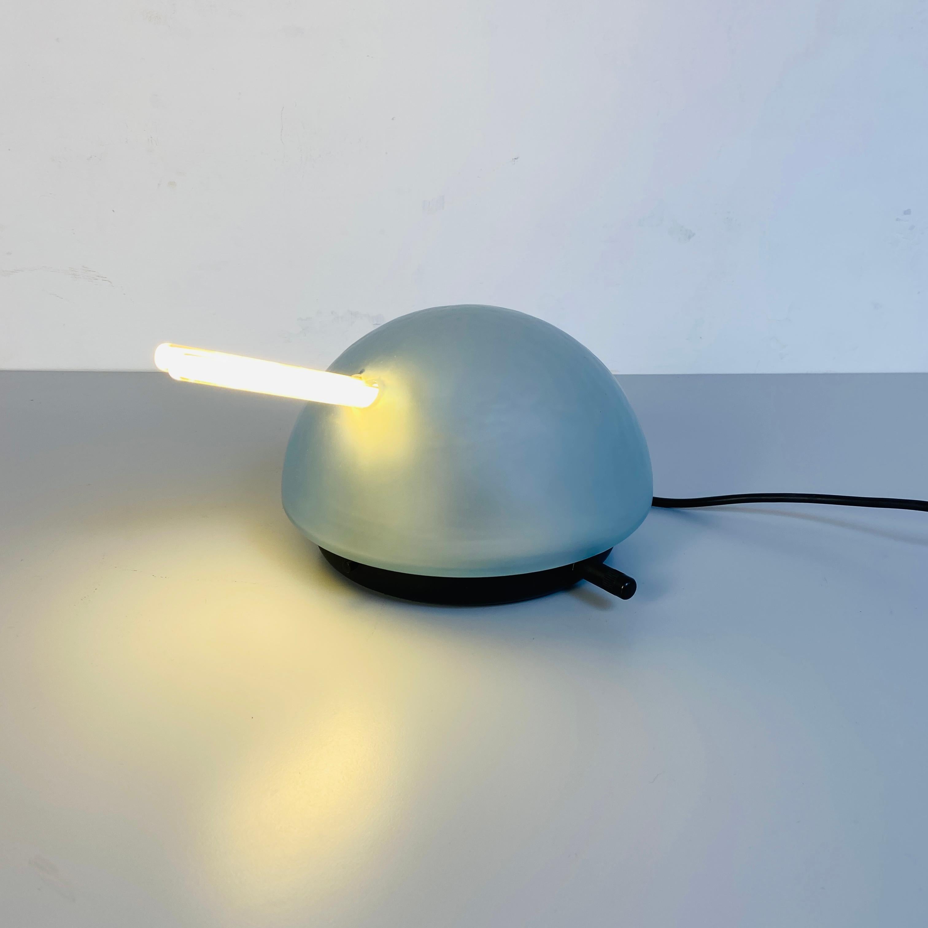Italian Mid-Century Modern satin glass table lamp mod. Tank by VeArt, 1980s
Extreme rare and fun table lamp mod. Tank, made up of a light blue round satin glass and black metal base. The lamp holder is internal, through a wheel it is possible to