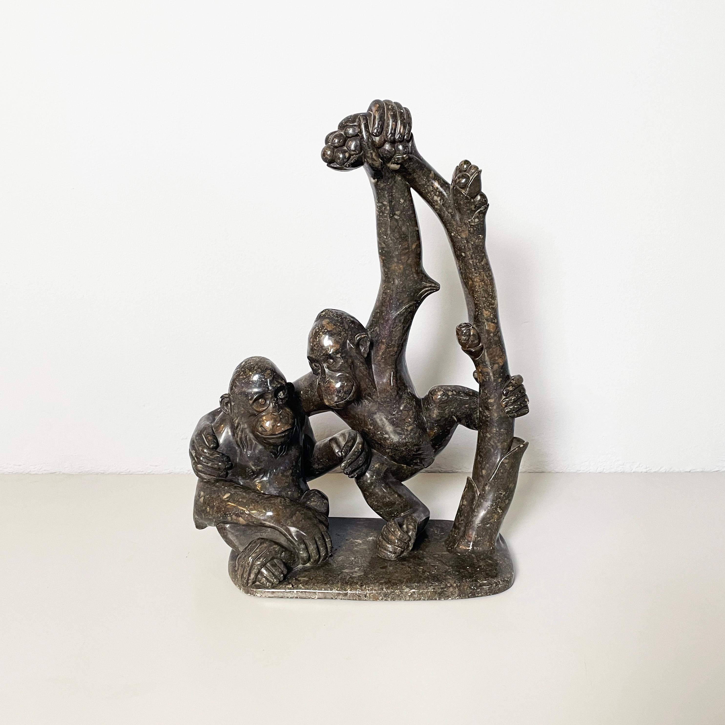 Italian Mid-Century modern Sculpture of monkeys in marble, 20th century
Sculpture depicting two monkeys, entirely in finely worked dark marble. The first monkey is sitting on the ground and the second is weighed down by a branch as it reaches