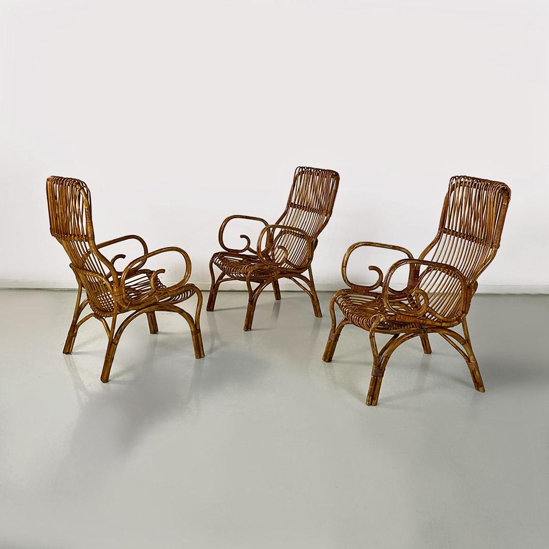 Italian mid century modern set of three curved lines rattan armchairs, 1960s
Set of three rattan armchairs, with curved lines, with curved armrest and round sections of various sizes. Seat and back composed of parallel strips, with interlacing in