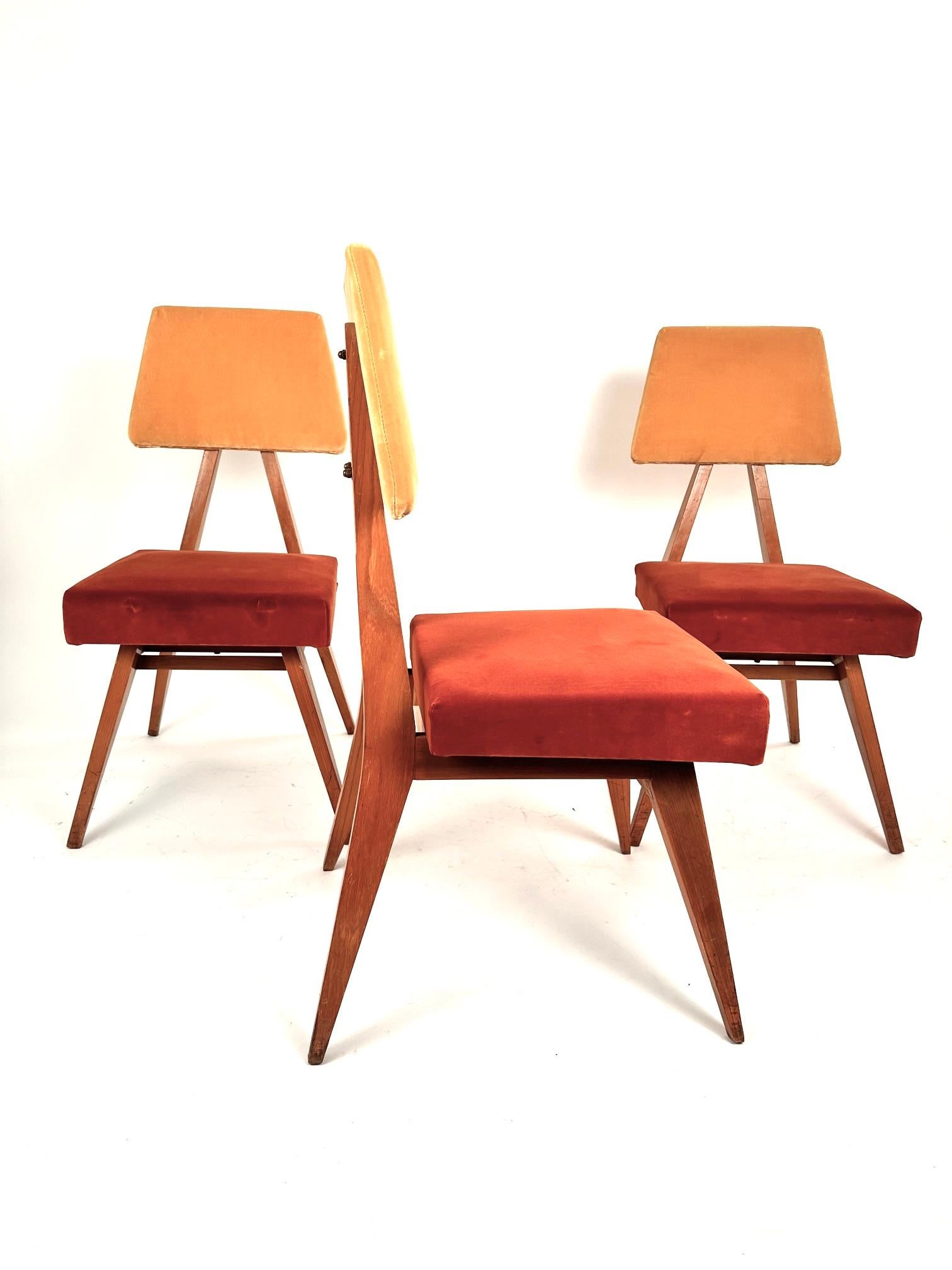 A rare set of Mid-Century Modern Italian dining  chairs designed by the Torino School in the 60s . The wood structure is a triangular frame on which lays a trapezoid back rest. Fine Italian manufacture.Reupholstered on Italian dark yellow and orange