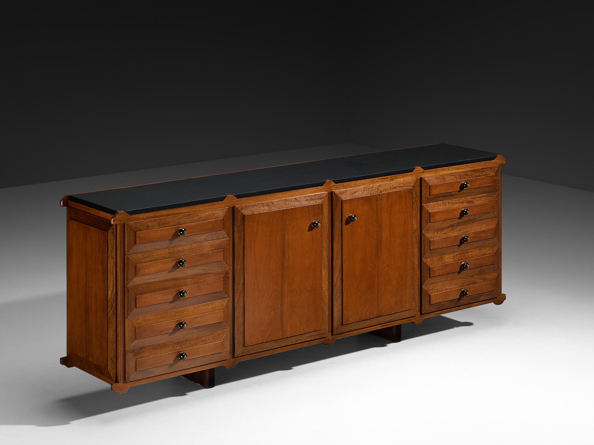 Sideboard, walnut, brass, faux leather, Italy, 1950s

Luxurious sideboard finished with elegant brass handles. The sideboard has six drawers on each side and two doors in the middle that provide plenty of storage space. The sideboard combines sturdy