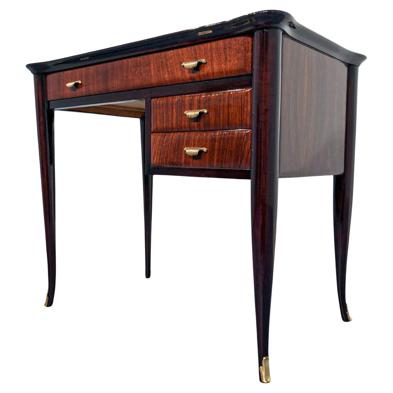 Cute and stylish Italian midcentury modern desk, with a graceful chair, attributed to Paolo Buffa. 
This teakwood desk it is a splendid example of the Italian class design of 1950.
Black glass tabletop with gold decorations, shaped on the sides,