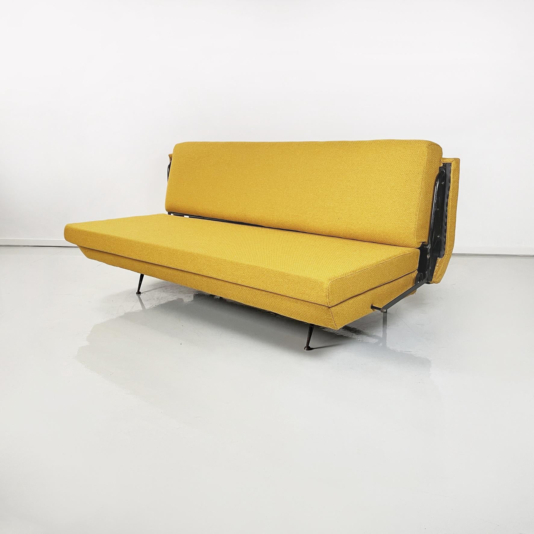 Italian Mid-Century Modern Sofa and bed in yellow fabric and black metal, 1960s
Sofa with padded rectangular seat and backrest, upholstered in mustard yellow fabric. The armrests have a black painted metal tubular structure, which allows the