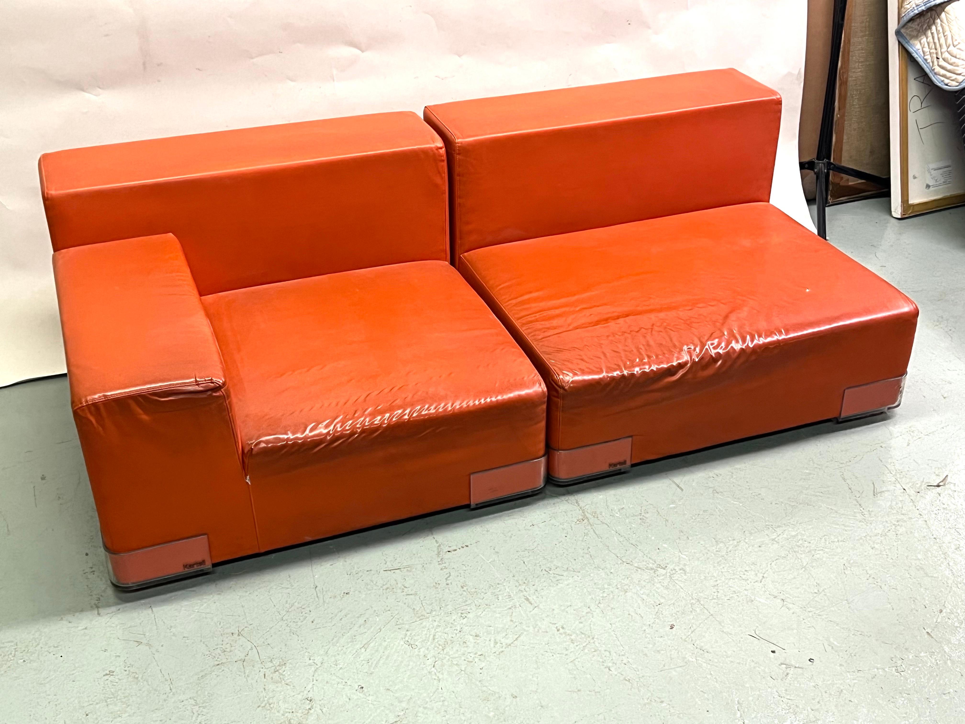 An Iconic Italian Mid-Century Sofa / Settee / Pair of Lounge Chairs by Piero Lissoni in a sleek, contemporary, low, square form circa 1970-1975. The sofa is modular, multi-functional and will form a pair of chairs. It is decorated in a bright orange
