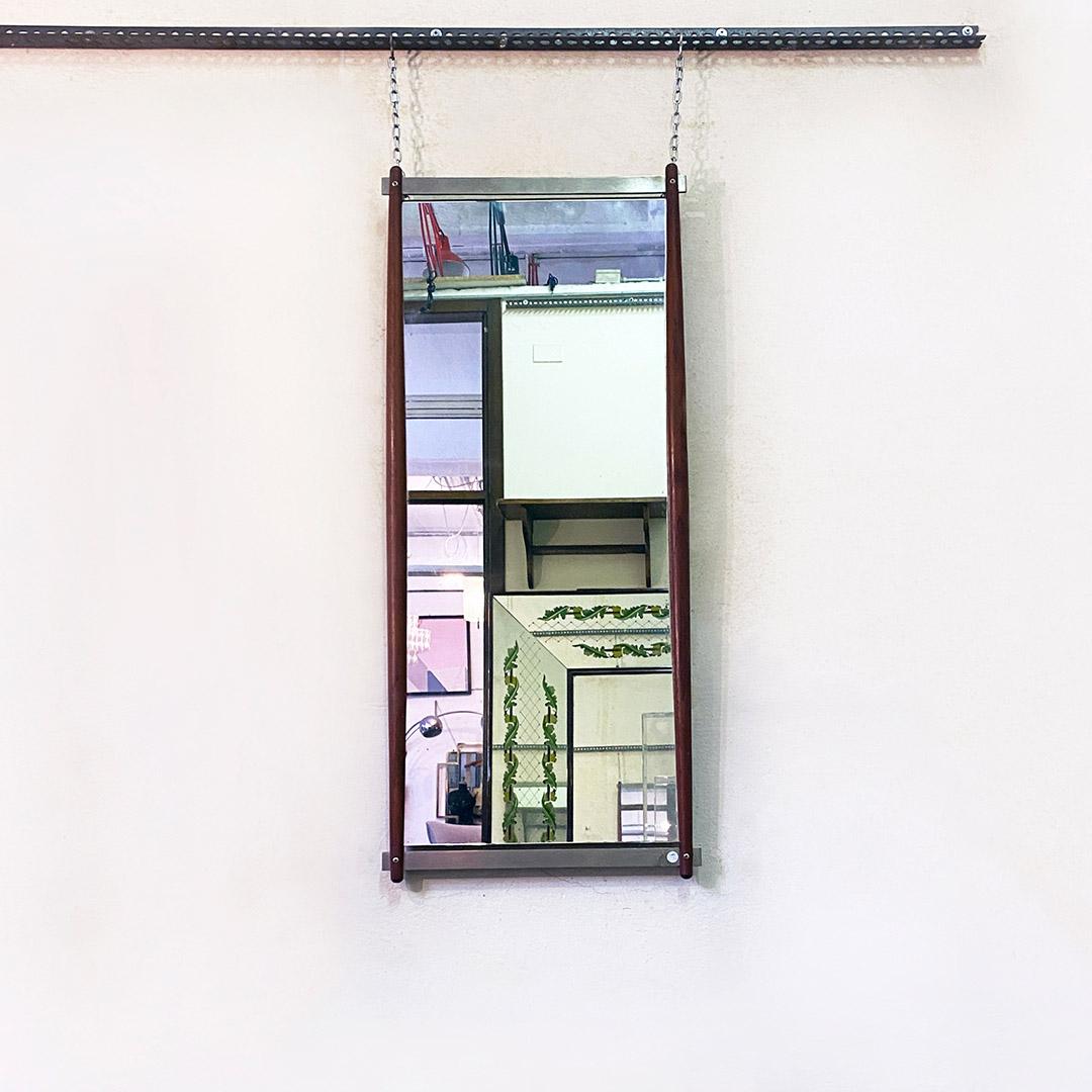 Italian Mid-Century Modern rectangular solid teak and brushed steel wall mirror by Stildomus, 1960s.
Rectangular mirror with structure composed of two long slats in shaped solid teak and two flat slats in brushed steel to close the frame. Steel
