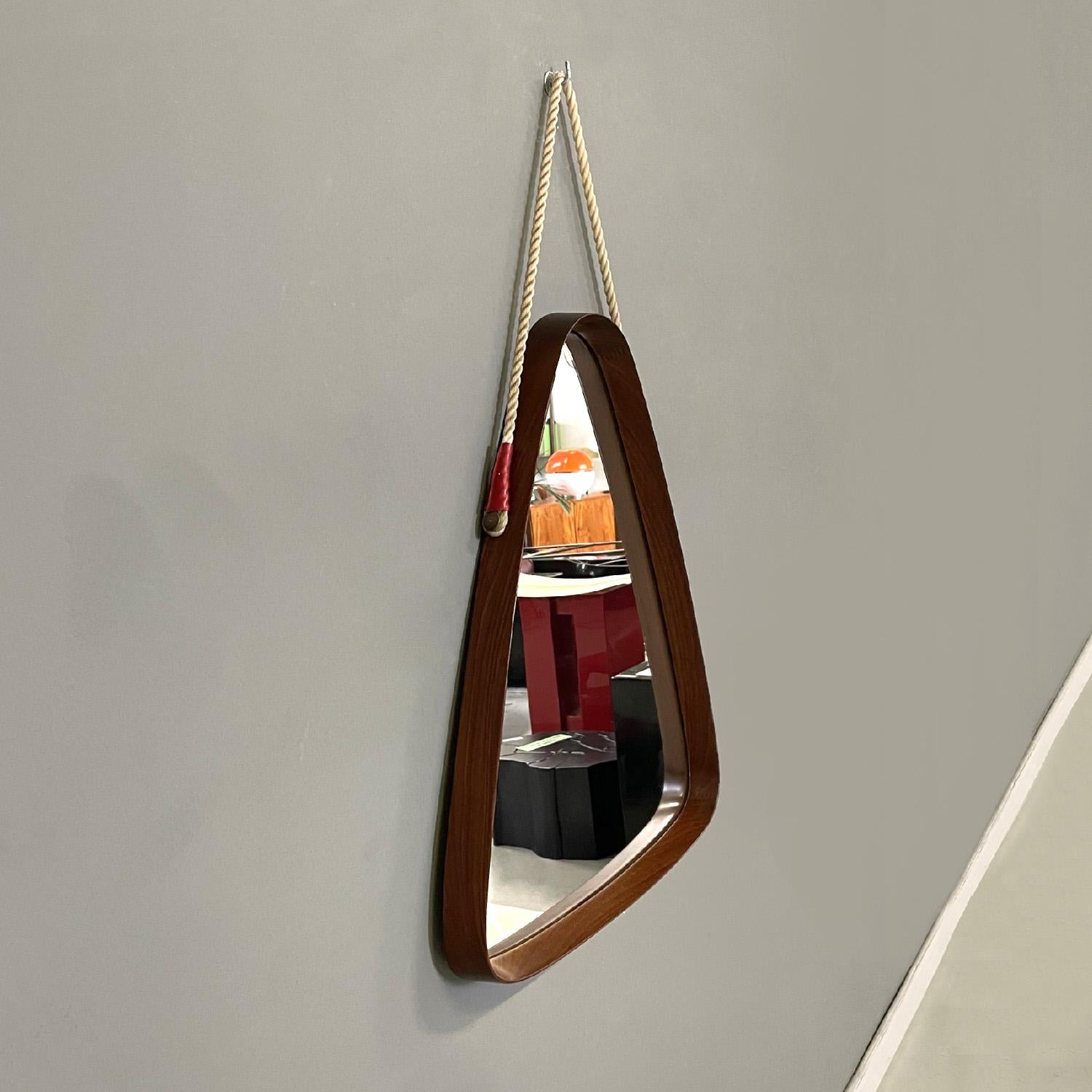 Italian mid-century modern solid wood triangular wall mirror with cord, 1960s
Triangular shaped wall mirror with rounded corners. Solid wood frame made up of different cuts of wood, note the slight difference in color and grain. It features a light
