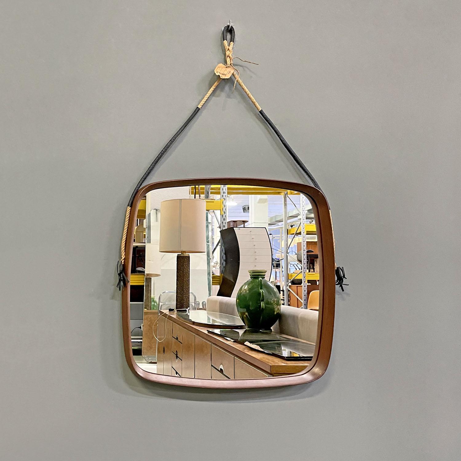 Italian mid-century modern squared wooden wall mirror with rope, 1960s
Square wooden wall mirror. The frame features soft, curved lines. The frame is thick and the mirror part remains internal. To hang the mirror on the wall there is a rope that