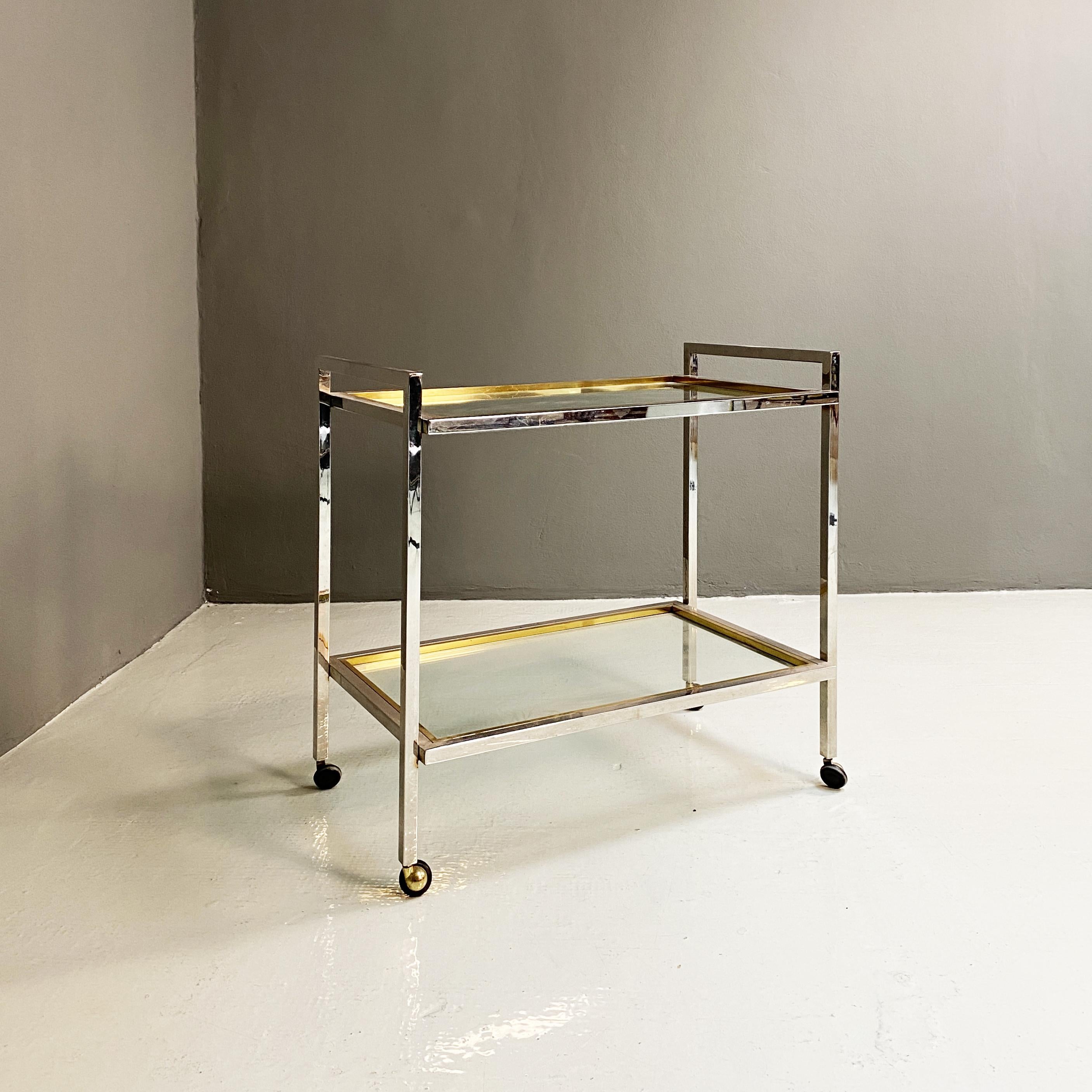 Italian Mid-Century Modern Steel and brass cart with two shelves, 1970s
Steel and brass cart on wheels with double glass shelf, with side handles.
1970s

Good conditions.

Measurements in cm 74x45x70H

 