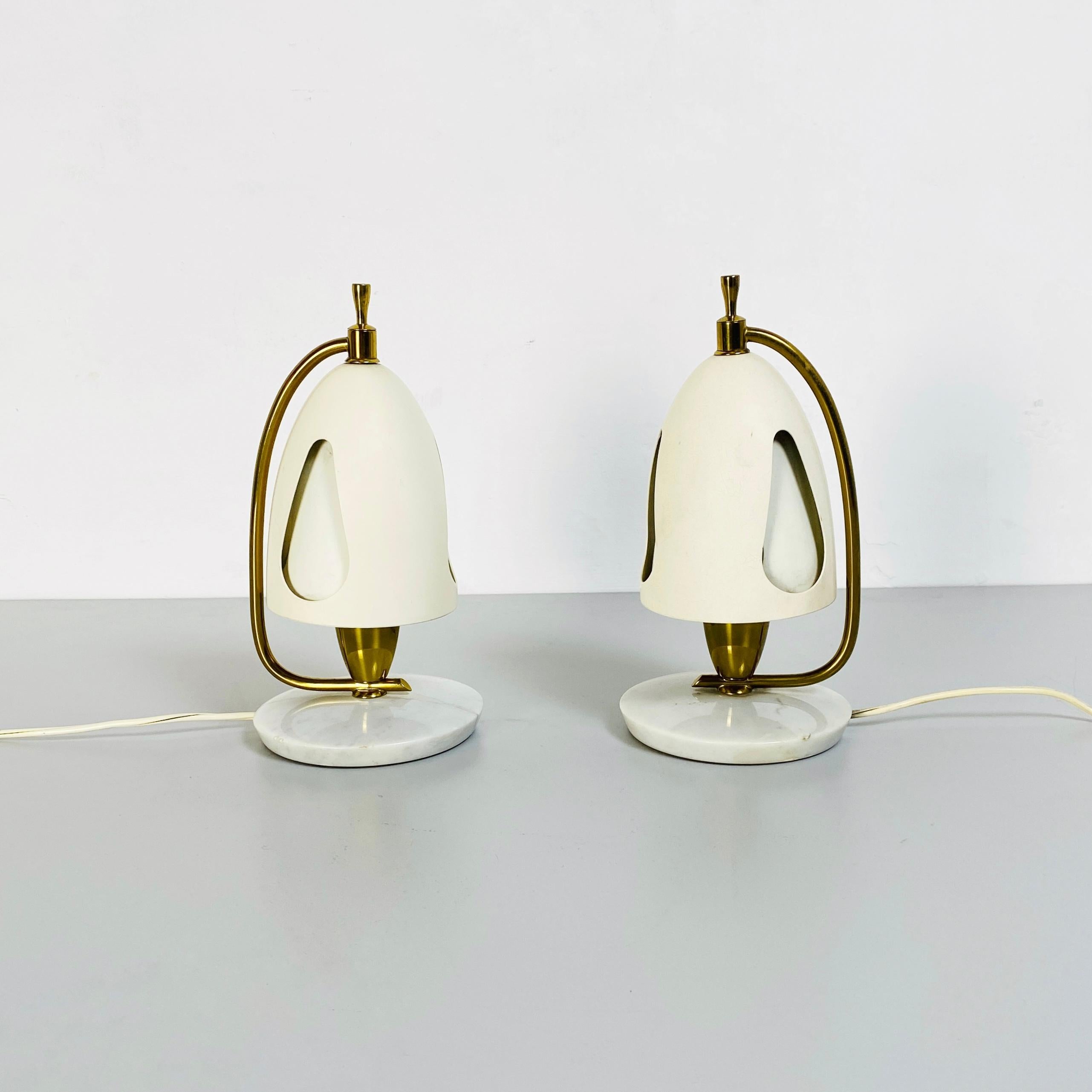 Very rare and fantastic  pair of table lamps mod. 12398,  composed of a base in marble carrara total white and white metal lampshade 
The structure of the lamp is in brass gold.
The principal particular of these lamps is the lampshade, that can be