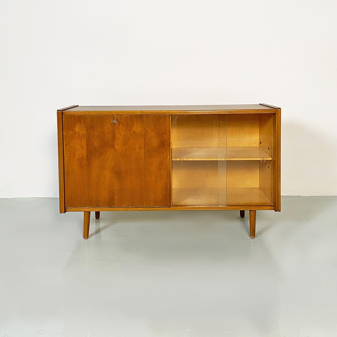 Italian Mid-Century Modern teak, beech and glass window cabinet or sideboard with shelves, 1970s
Display cabinet or sideboard of Northern European origin, in teak wood, with flap on one side with internal shelf, and visible part with sliding glass