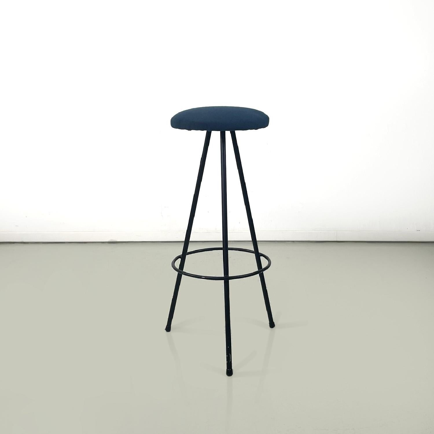 Italian mid-century modern three legs black metal and blue fabric stool, 1950s
High bar stool with round base. The seat is round and is in blue fabric. The legs are made of black painted metal rod with a rounded foot and are joined by a