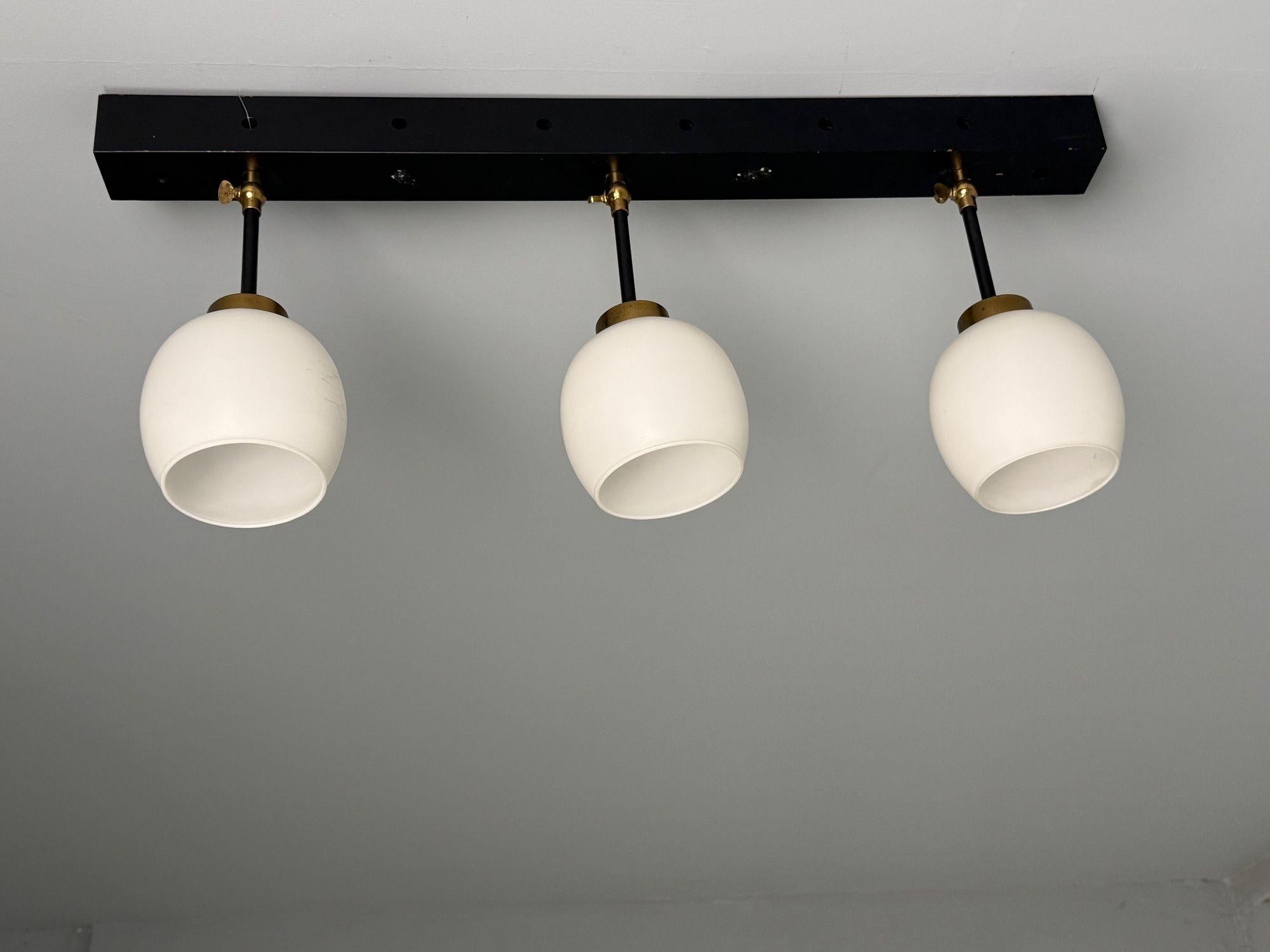 Italian Mid-Century Modern, Three Light Wall Sconce, Painted Metal, Glass, 1950s



This striking single wall sconce, designed and produced in Italy during the mid-20th century, features a sleek long painted metal frame that embodies modern